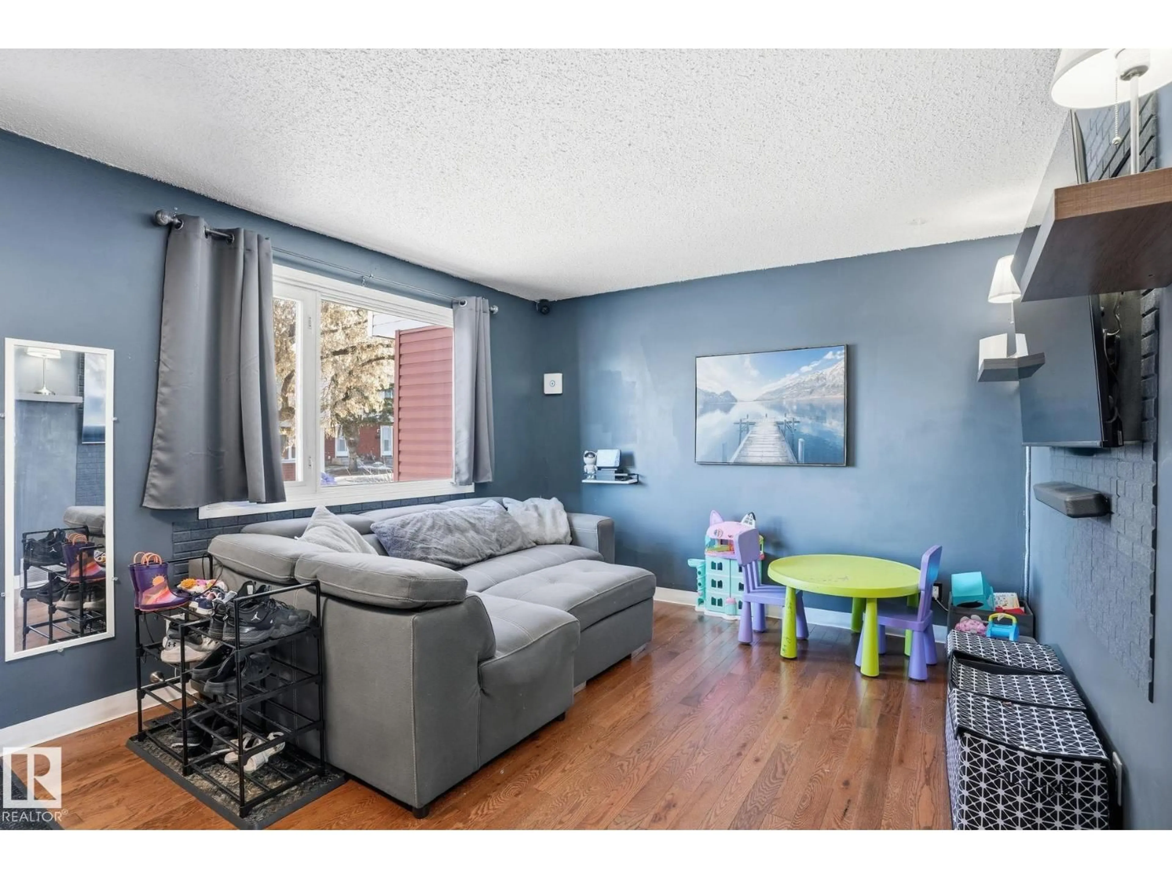 Living room with furniture, wood/laminate floor for 160 HABITAT CR, Edmonton Alberta T5A2X7