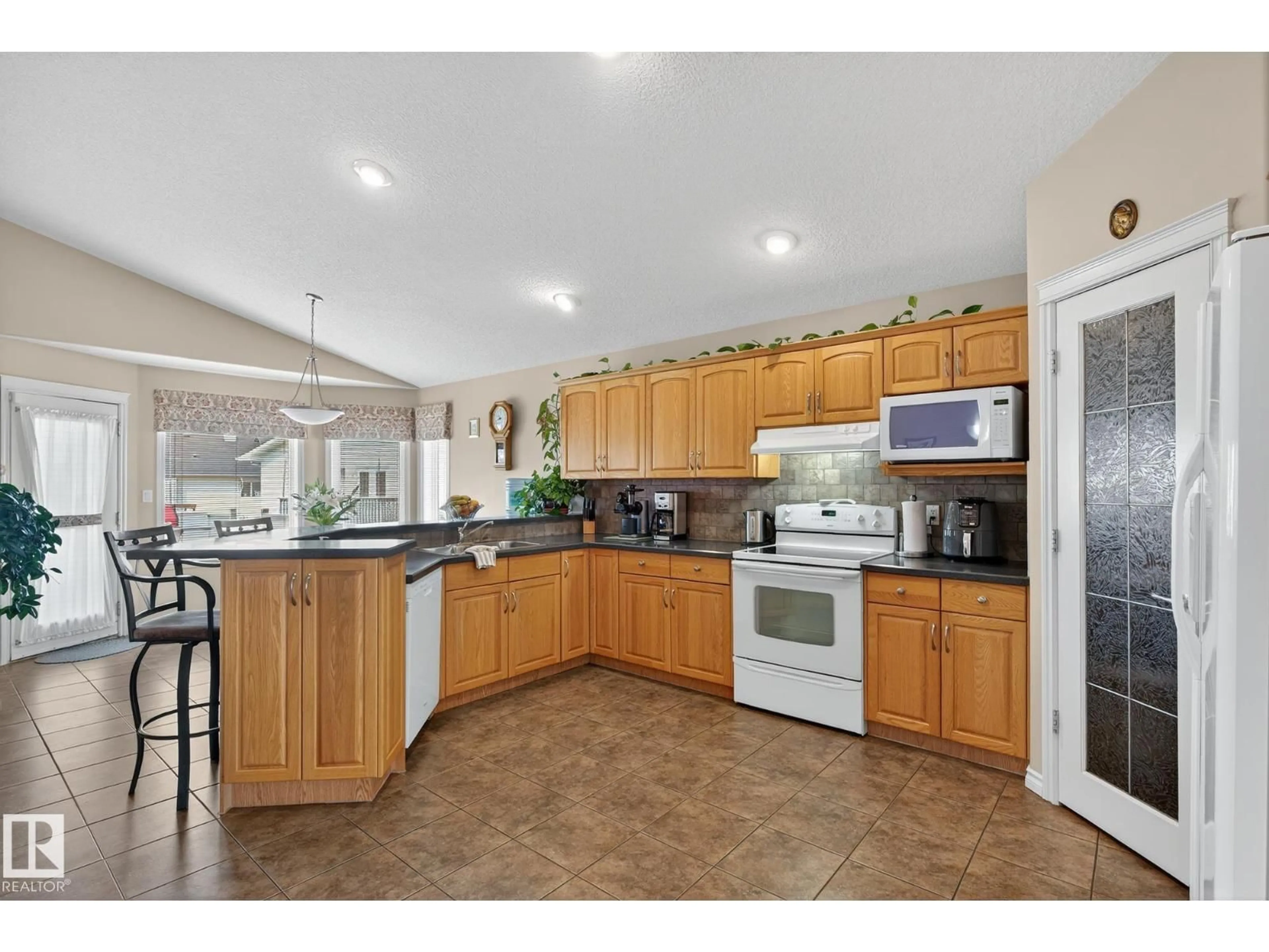 Open concept kitchen, ceramic/tile floor for 7335 164 AV, Edmonton Alberta T5Z3Y3