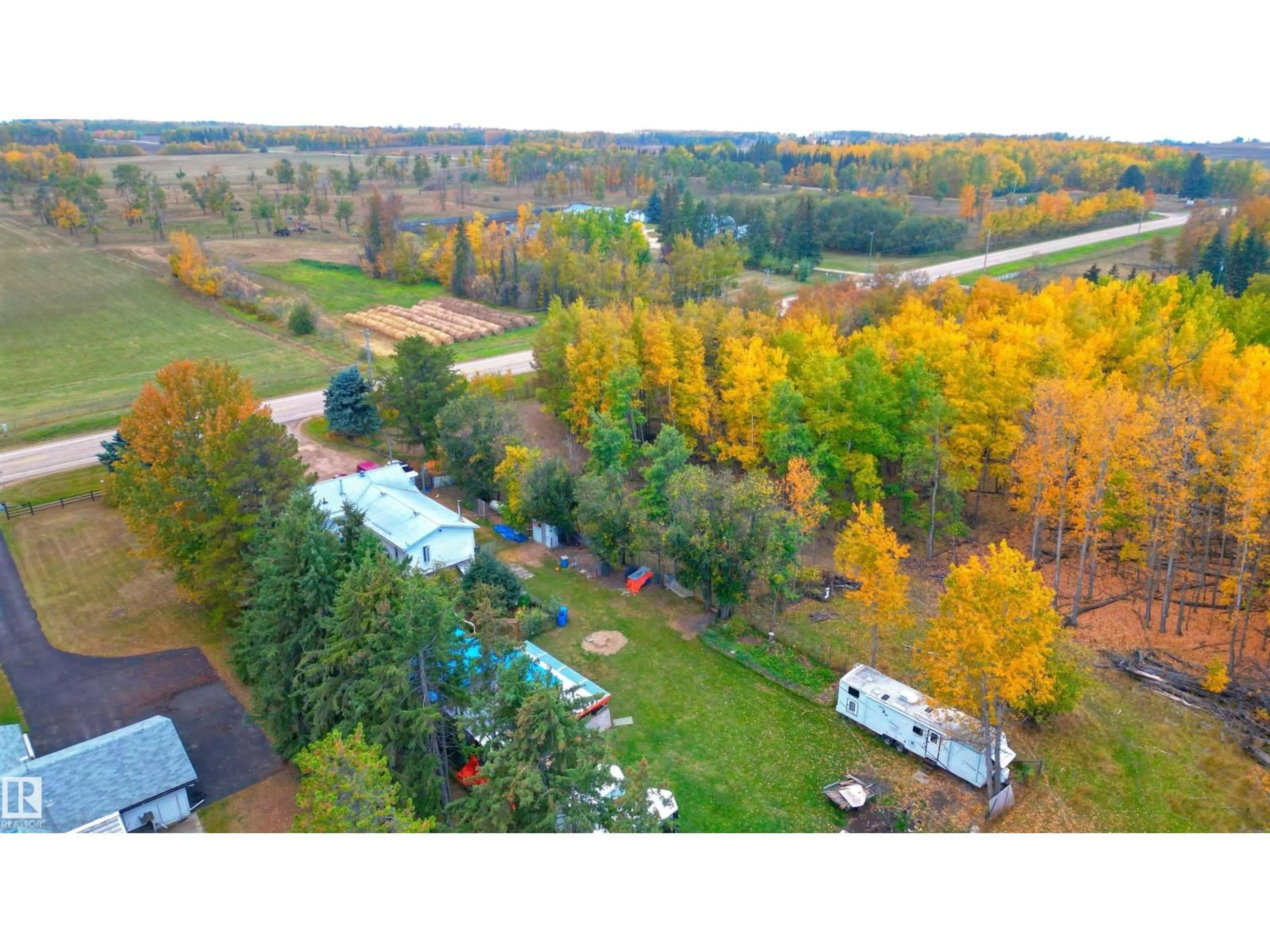 A pic from outside/outdoor area/front of a property/back of a property/a pic from drone, forest/trees view for 273064 HWY 13, Rural Wetaskiwin County Alberta T9A1W8