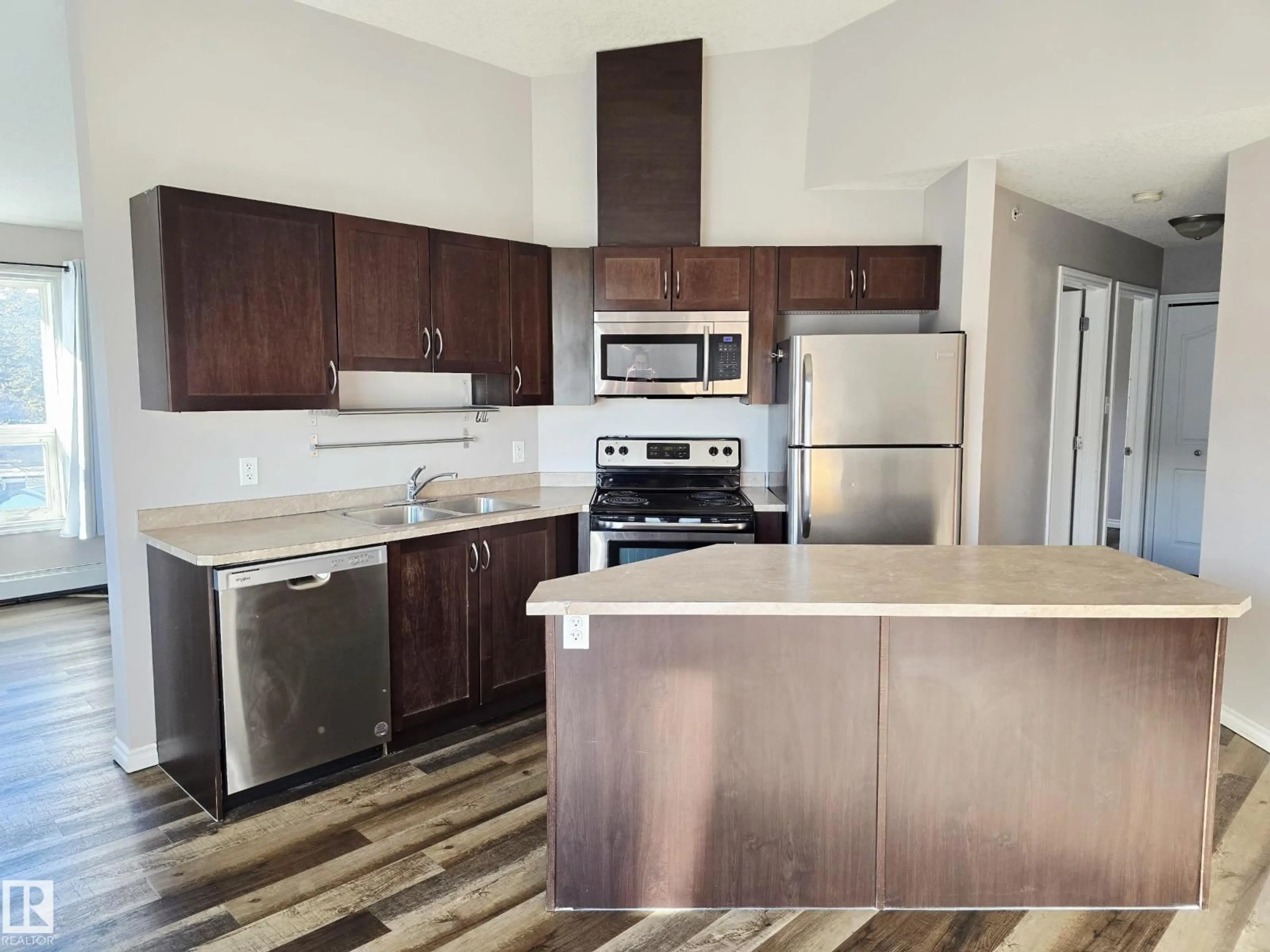 Open concept kitchen, wood/laminate floor for #401 - 10710 116 ST, Edmonton Alberta T5N3A5