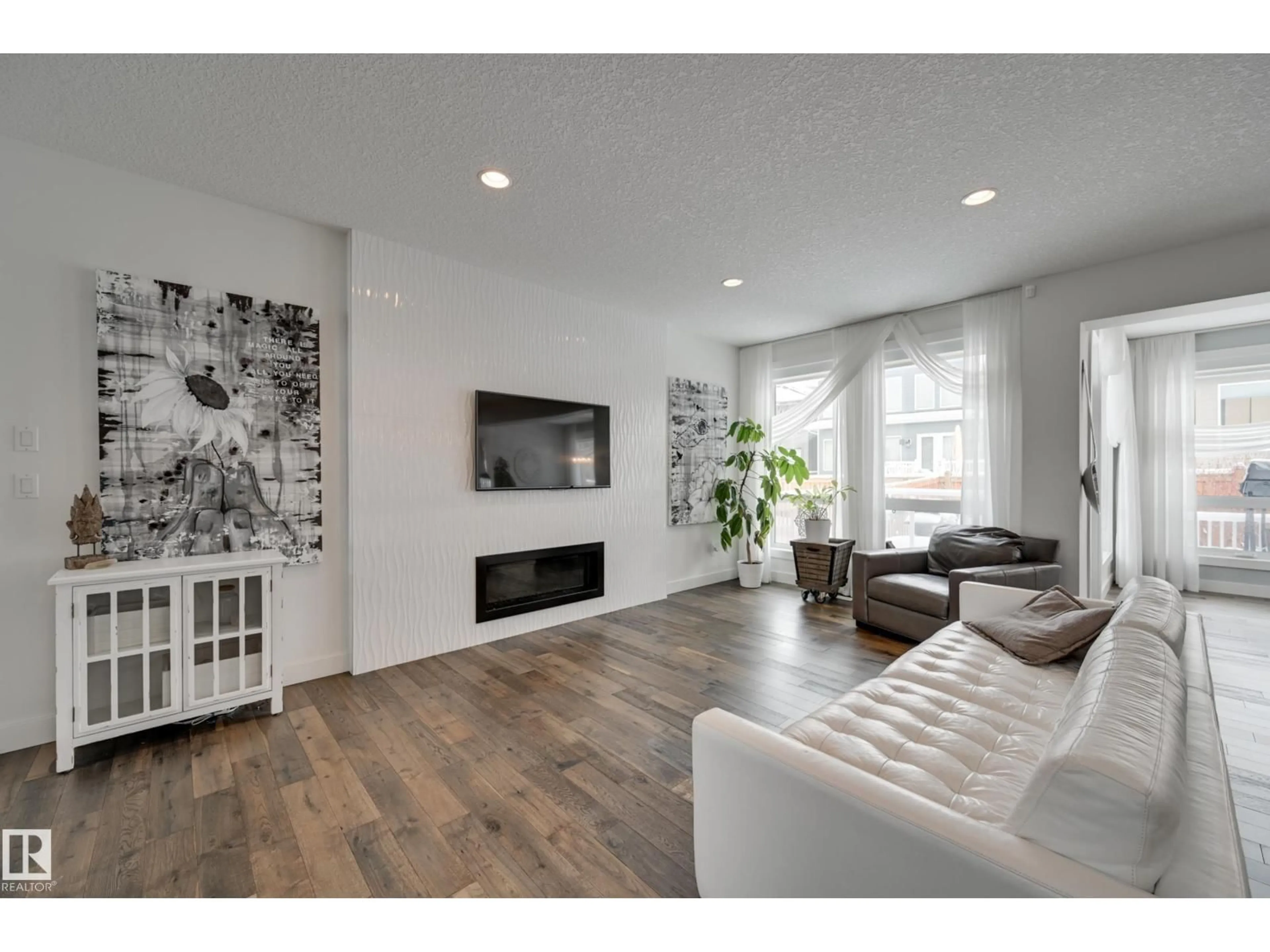 Living room with furniture, wood/laminate floor for 1311 HAINSTOCK WY, Edmonton Alberta T6W3B6