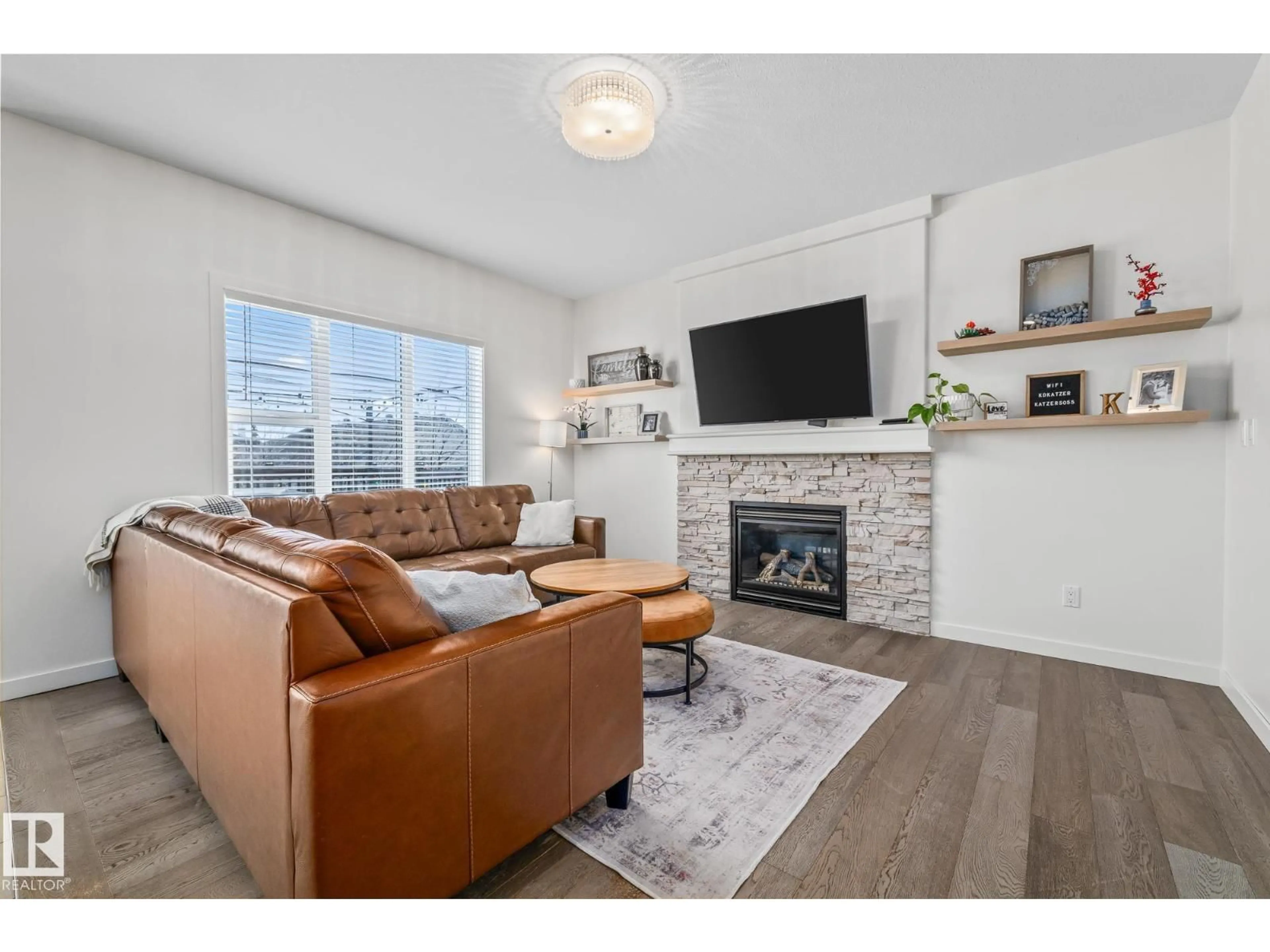 Living room with furniture, wood/laminate floor for 5713 42 ST, Beaumont Alberta T4X0C2