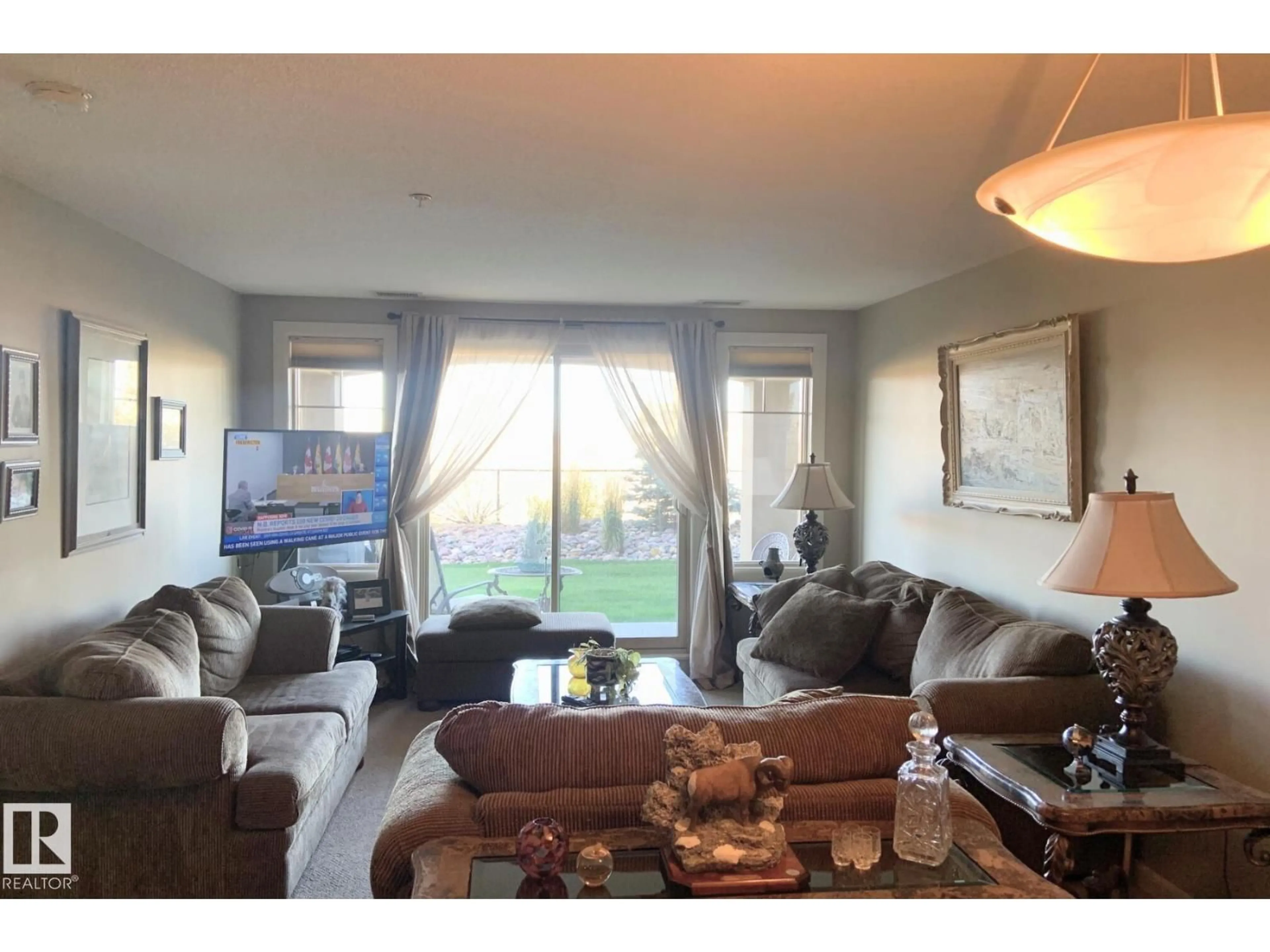 Living room with furniture, wood/laminate floor for 400 - 117 PALISADES WAY, Sherwood Park Alberta T8H0H4