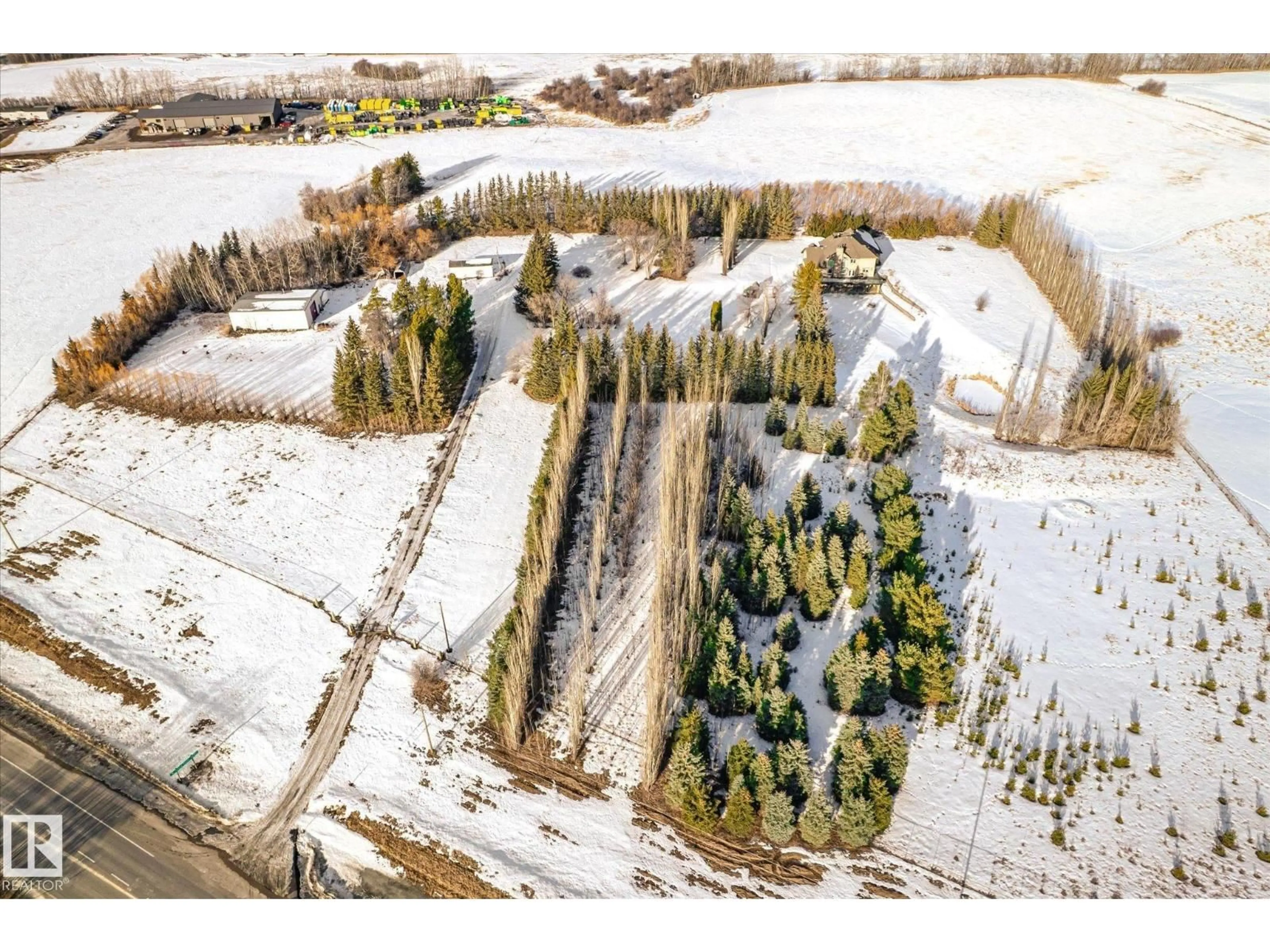 A pic from outside/outdoor area/front of a property/back of a property/a pic from drone, forest/trees view for HI - 27510 HWY 37, Rural Sturgeon County Alberta T8R0J2