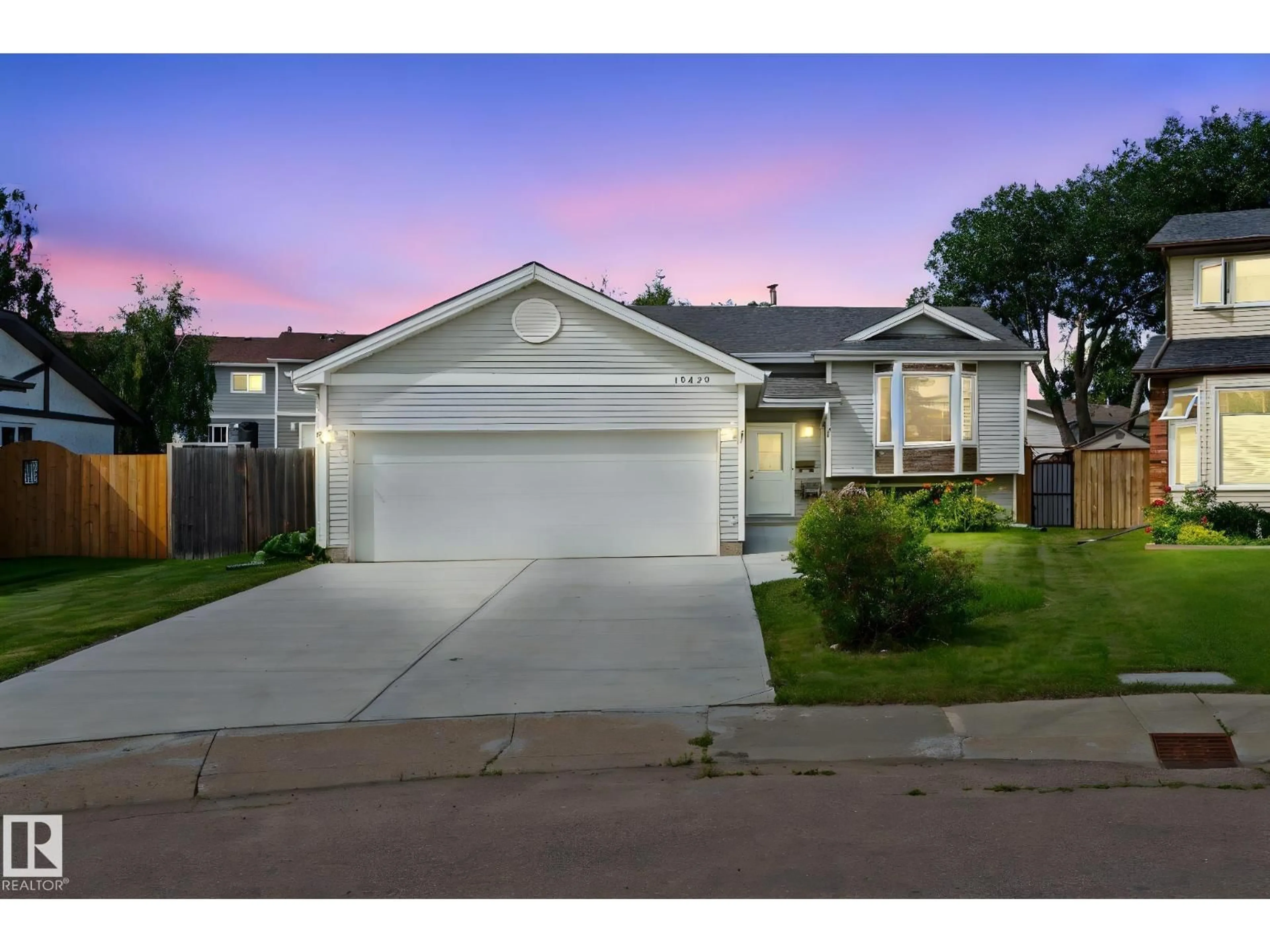 Home with vinyl exterior material, street for 10458 14 AV, Edmonton Alberta T6J5S9