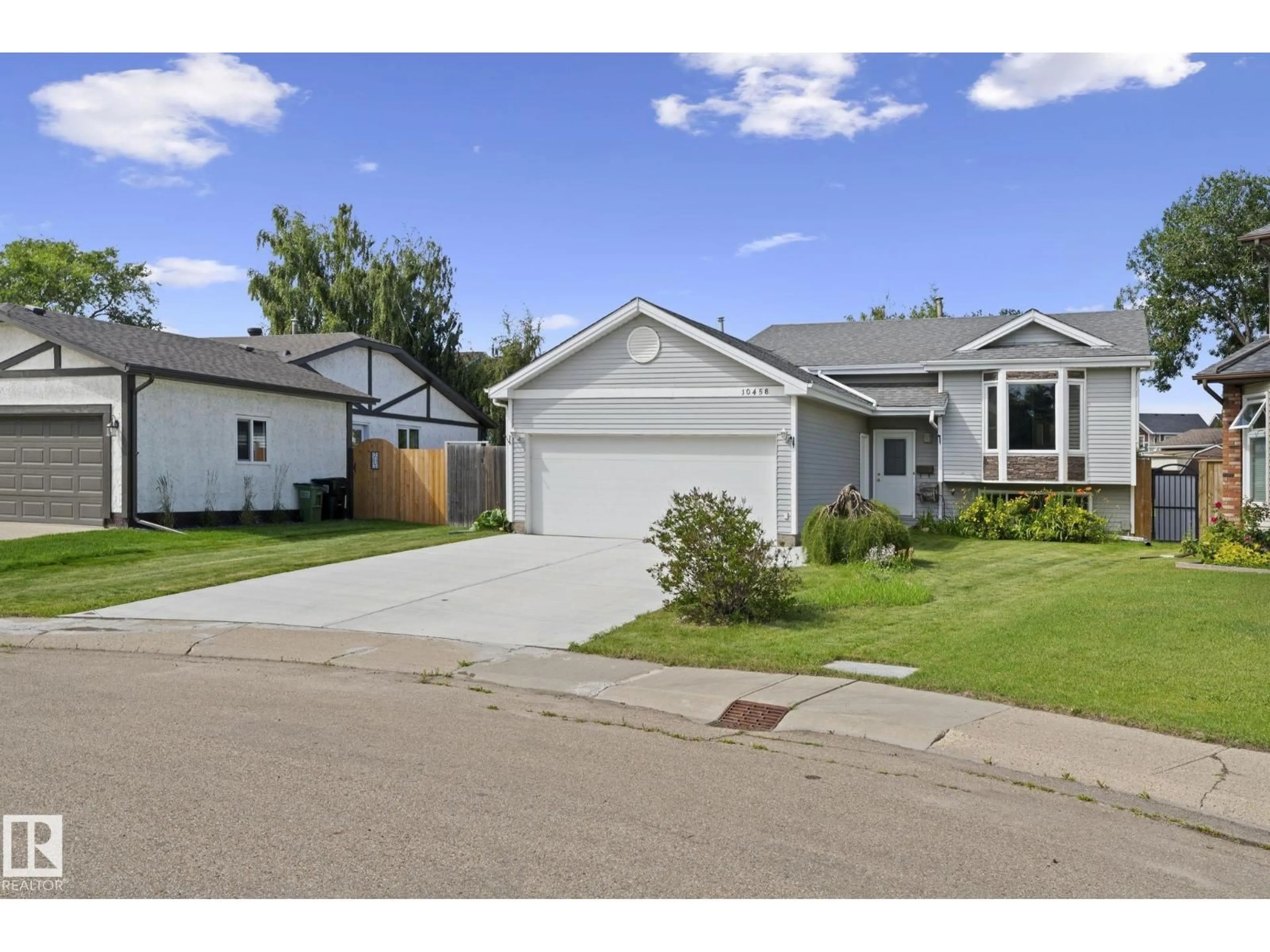 Home with vinyl exterior material, street for 10458 14 AV, Edmonton Alberta T6J5S9