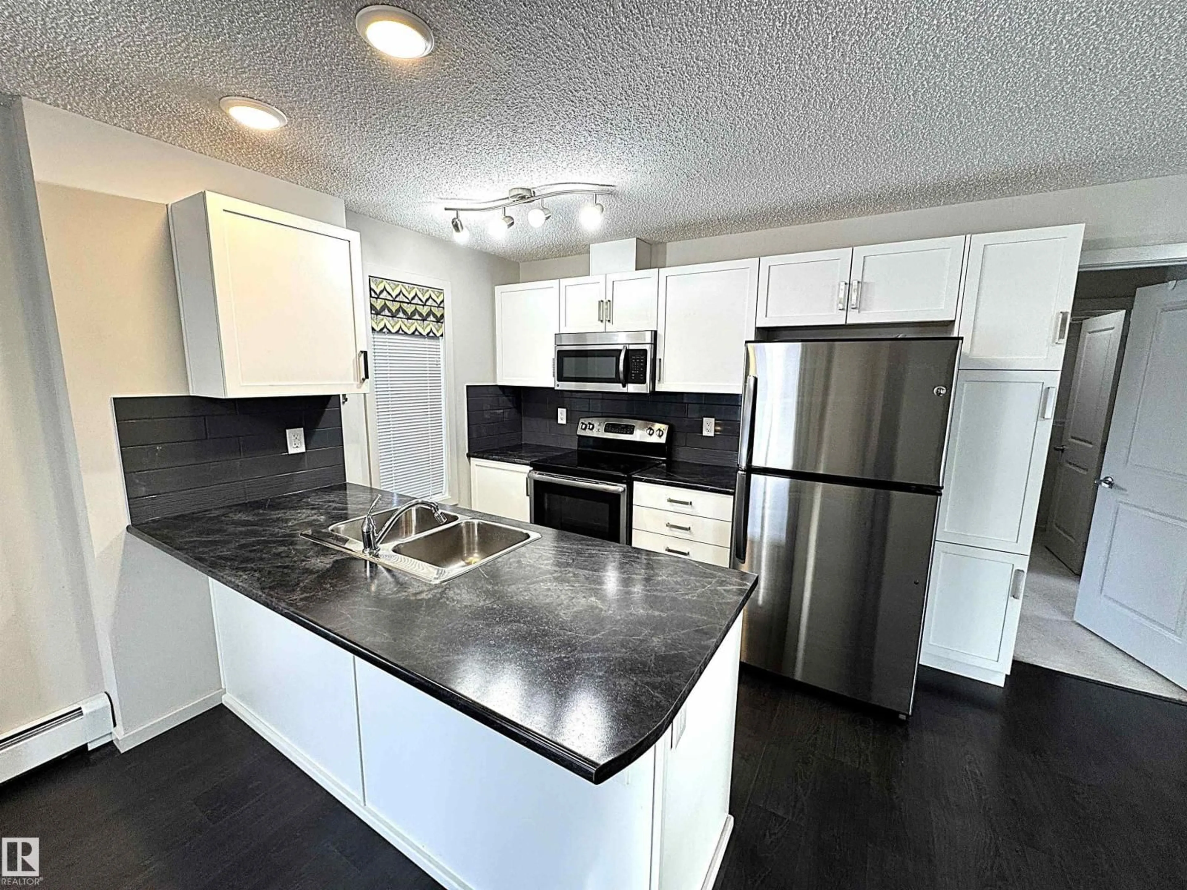 Open concept kitchen, unknown for #117 - 5521 7 AV, Edmonton Alberta T6X2A8