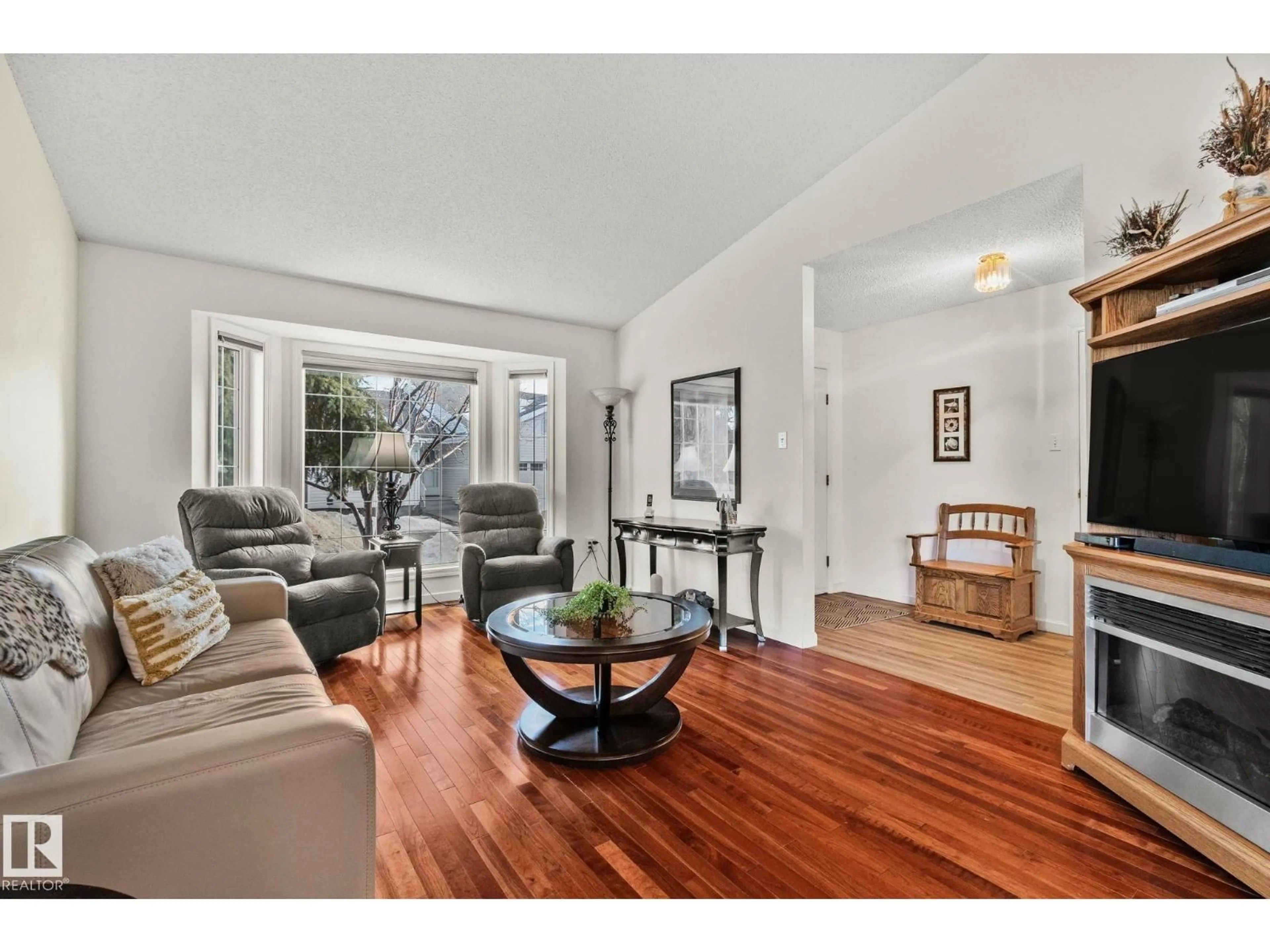 Living room with furniture, wood/laminate floor for #10 - 13217 155 AV NW, Edmonton Alberta T6V1E6