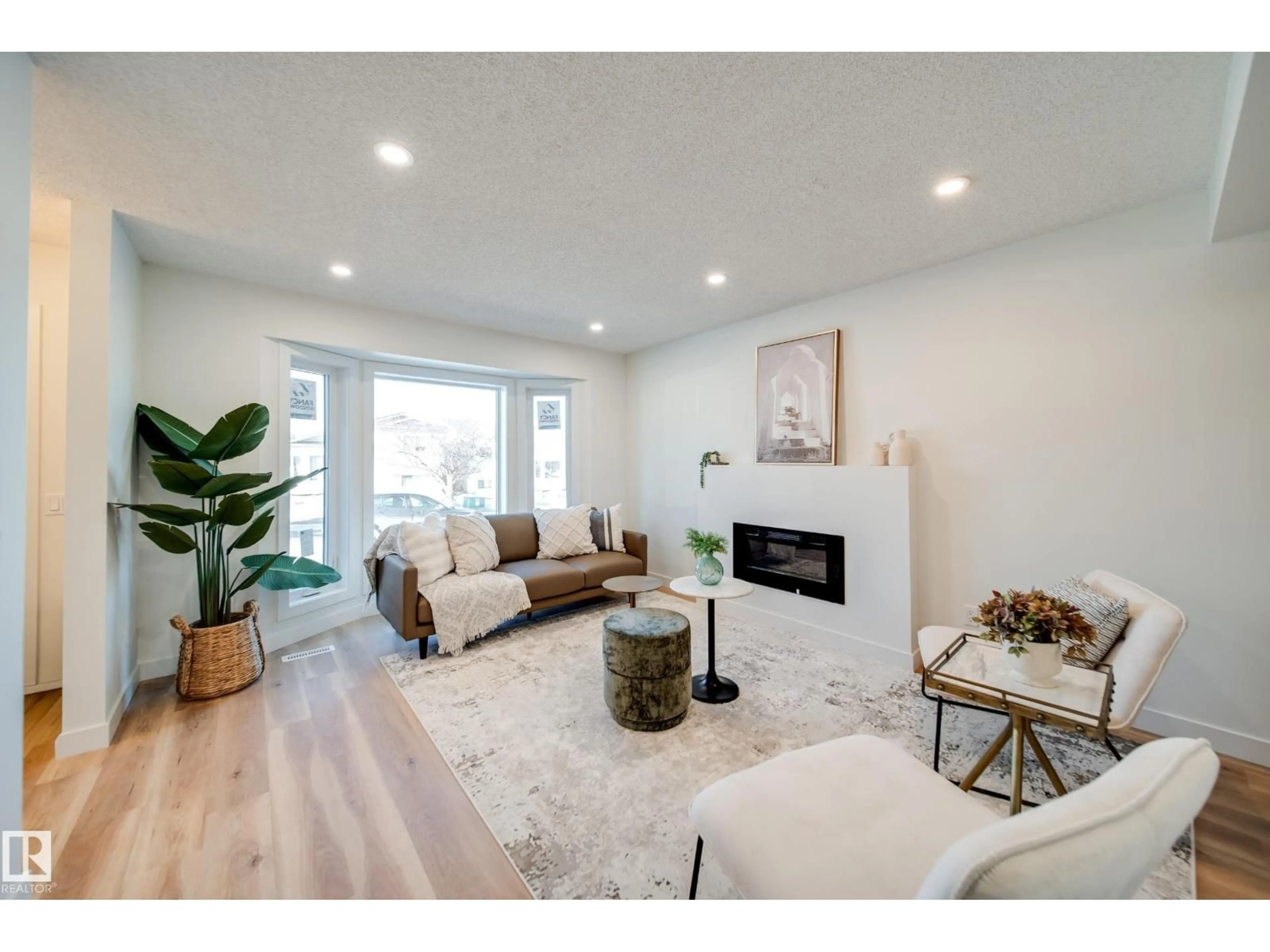 Living room with furniture, wood/laminate floor for 4019 37 ST, Edmonton Alberta T6L6H2