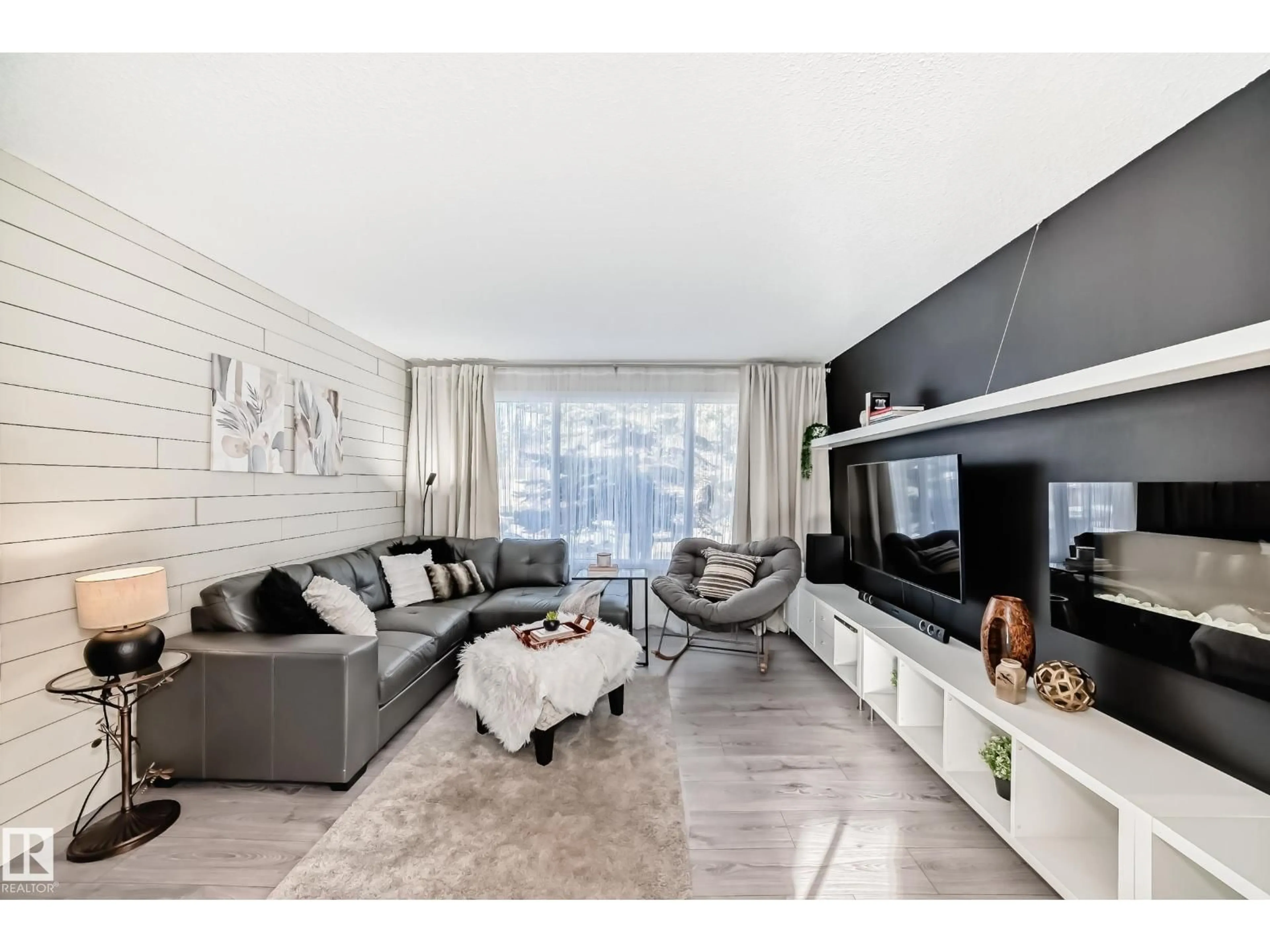 Living room with furniture, wood/laminate floor for 6111 18 AV NW, Edmonton Alberta T6L1M9