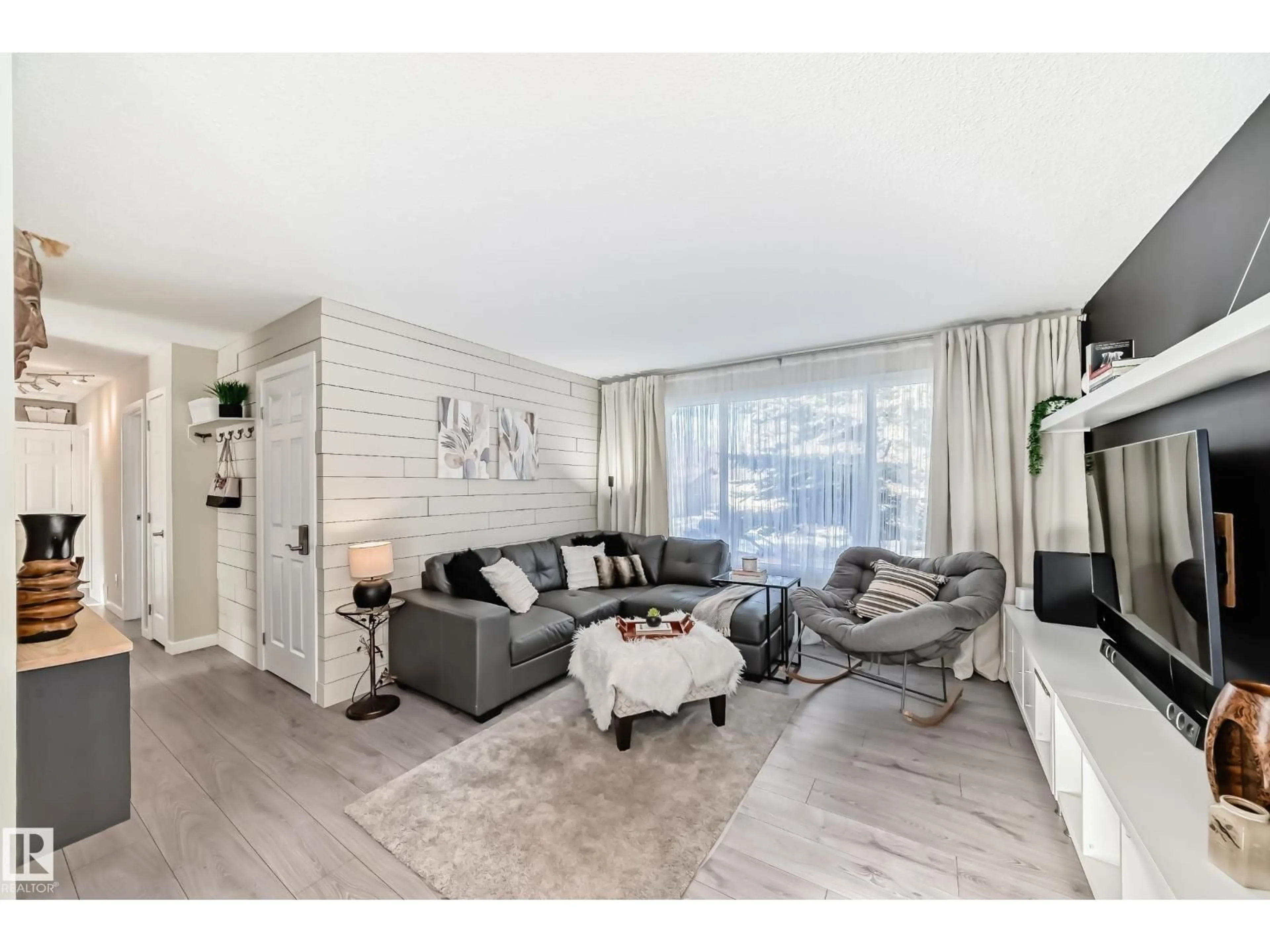 Living room with furniture, wood/laminate floor for 6111 18 AV NW, Edmonton Alberta T6L1M9