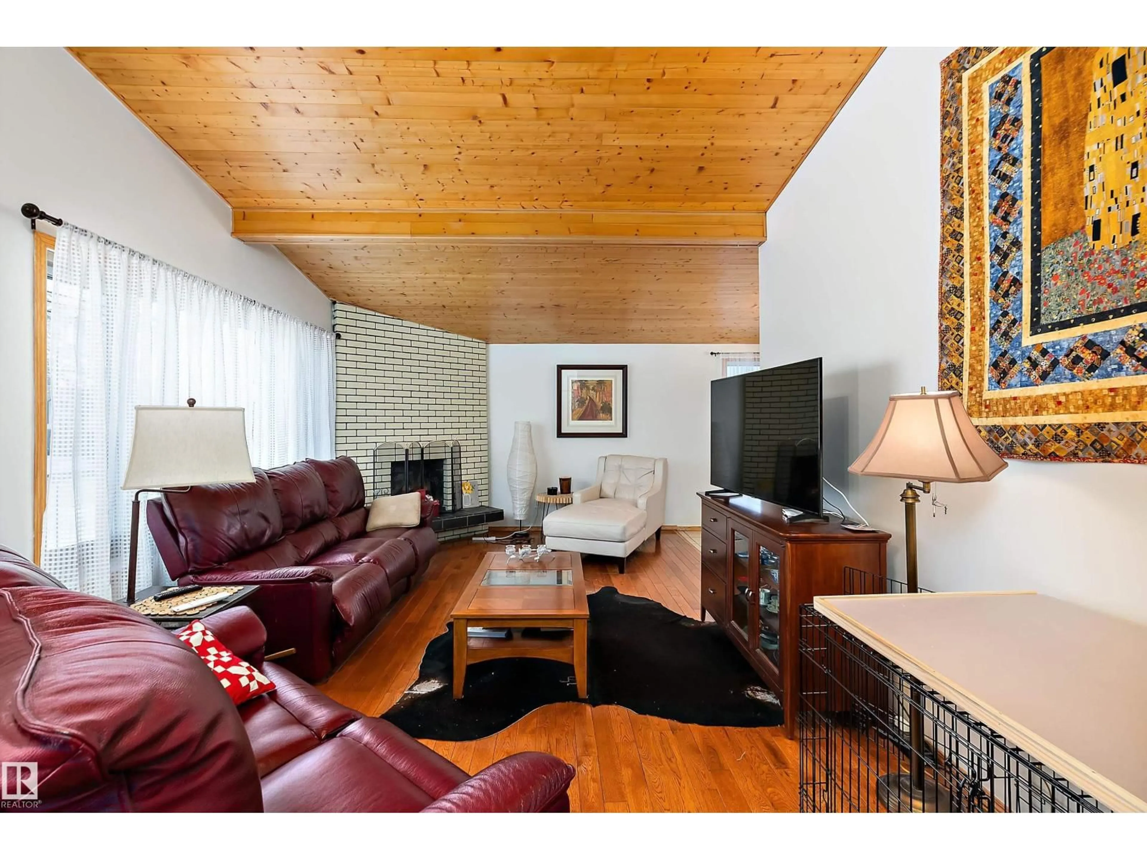 Living room with furniture, wood/laminate floor for 7 MOHAWK CR, Leduc Alberta T9E4G4