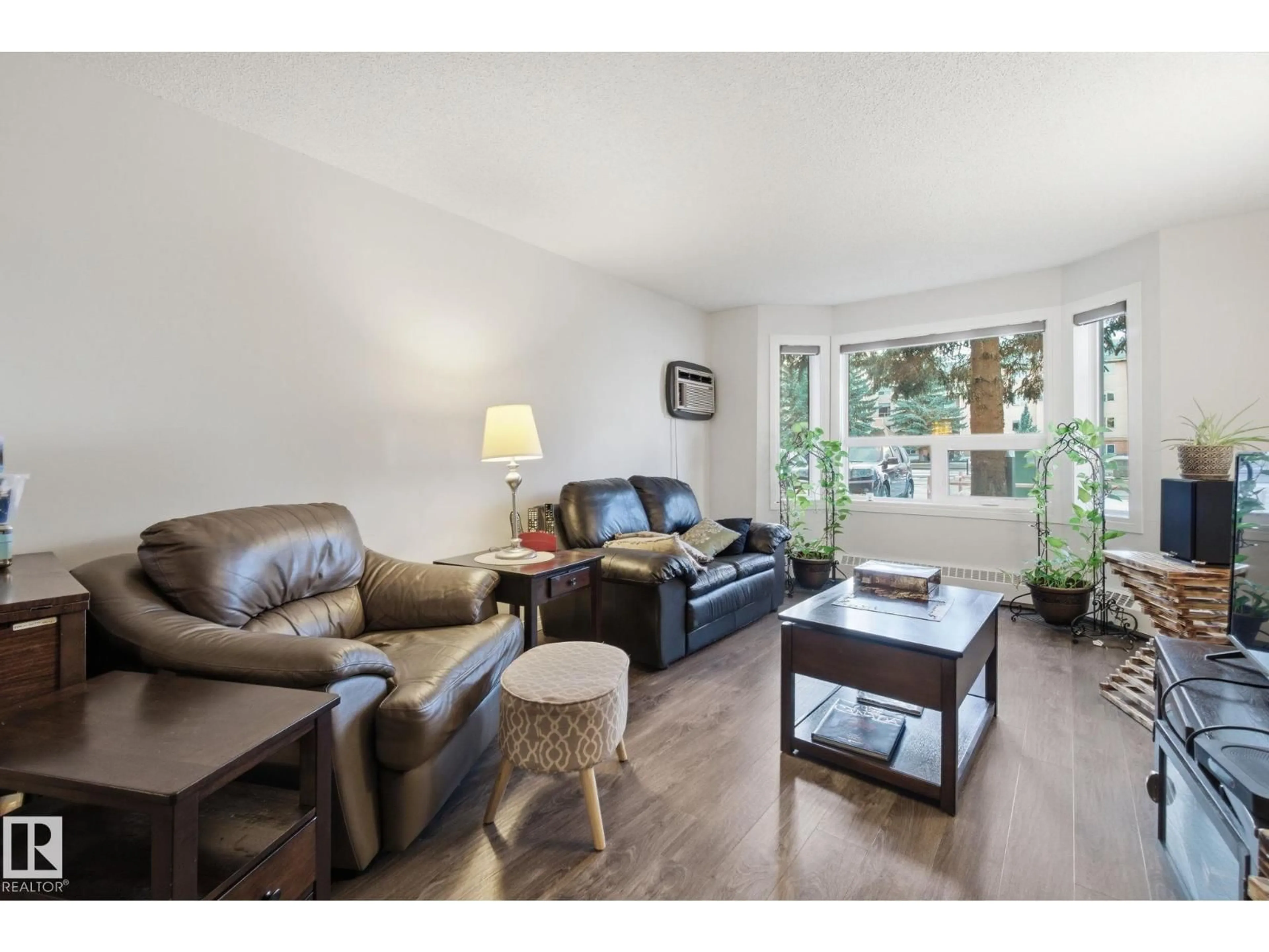 Living room with furniture, wood/laminate floor for #113 - 10935 21 AV, Edmonton Alberta T6J6R3