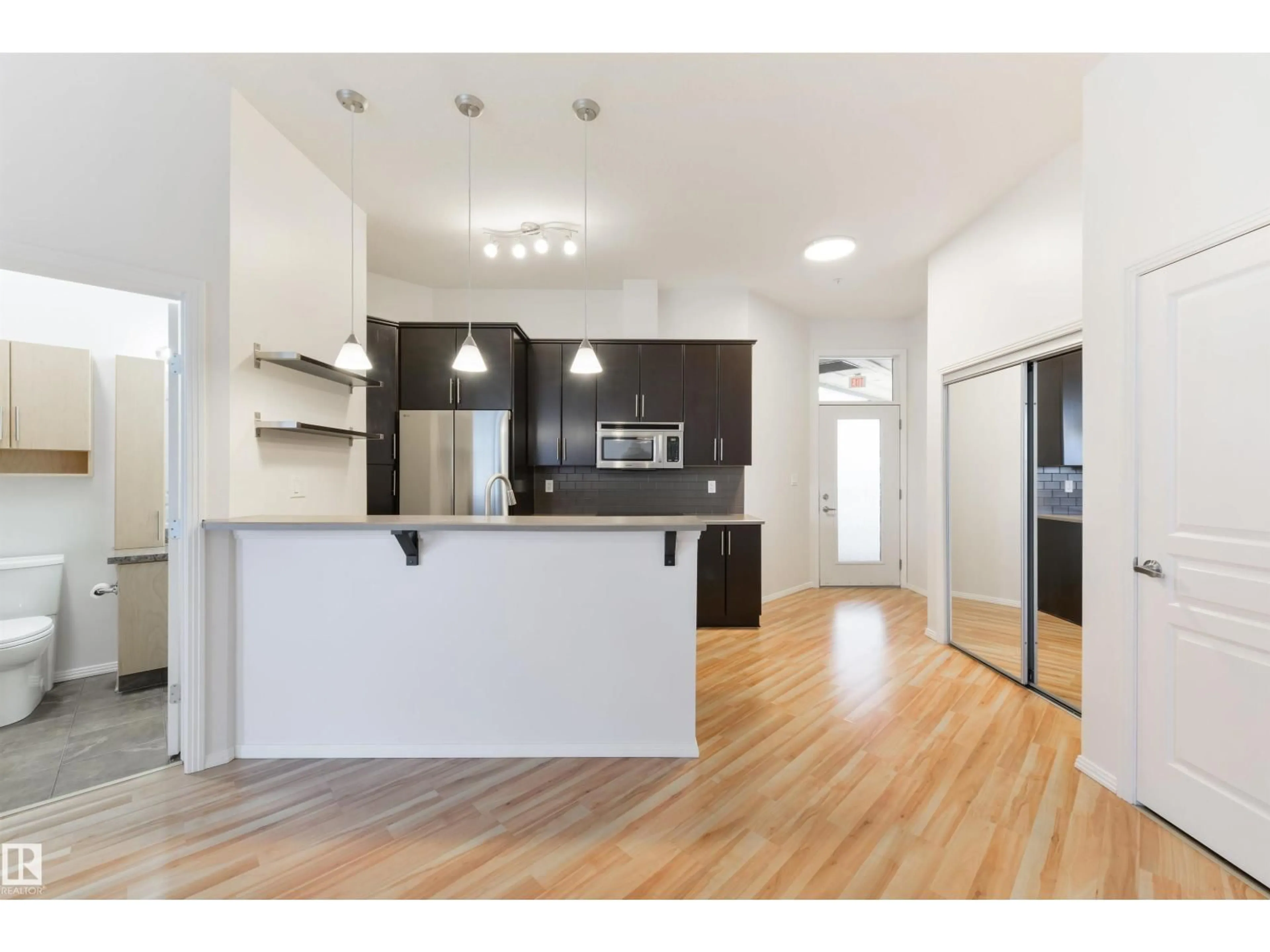 Open concept kitchen, wood/laminate floor for #405 - 10531 117 ST, Edmonton Alberta T5H0A8
