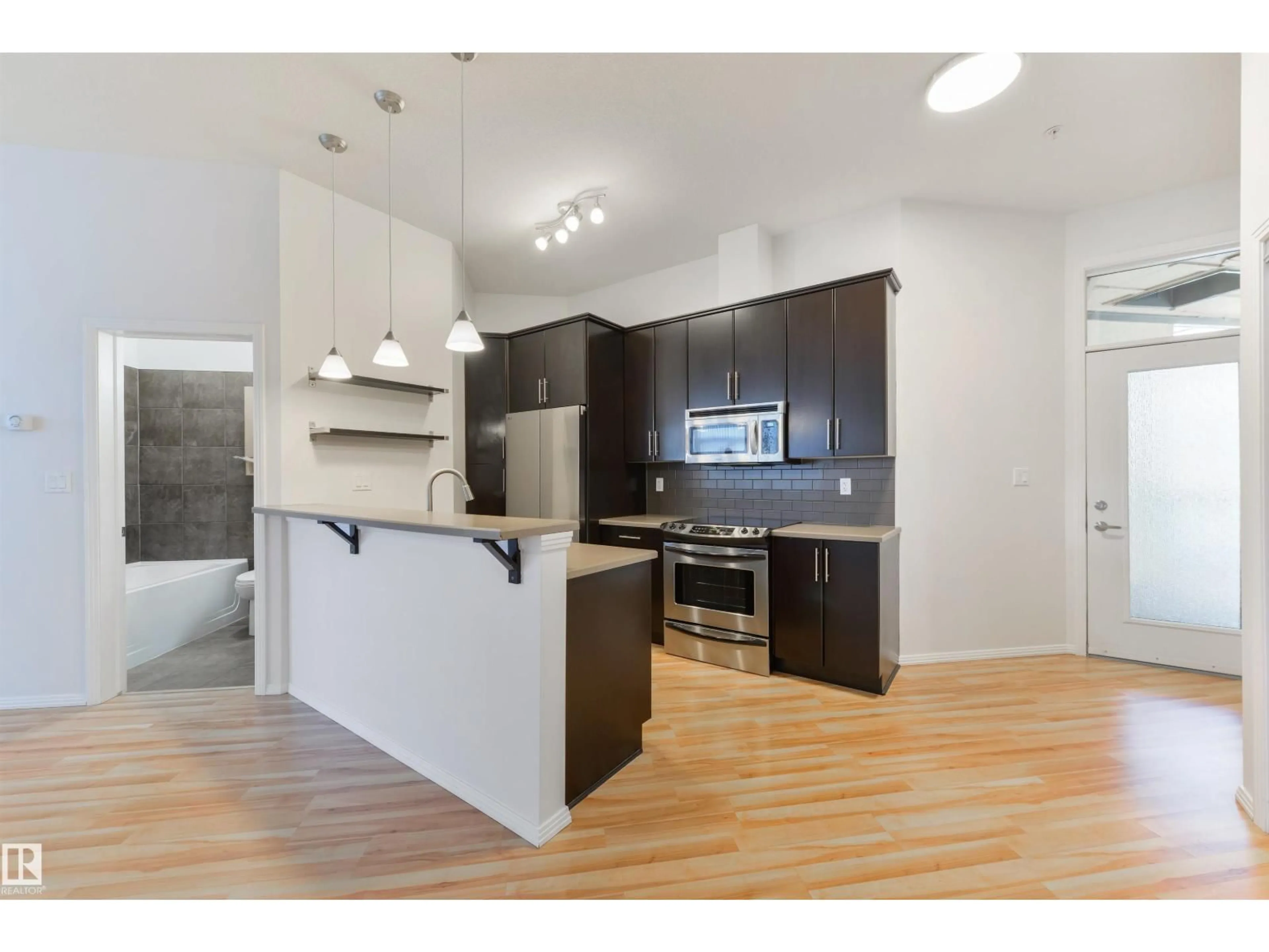 Open concept kitchen, wood/laminate floor for #405 - 10531 117 ST, Edmonton Alberta T5H0A8