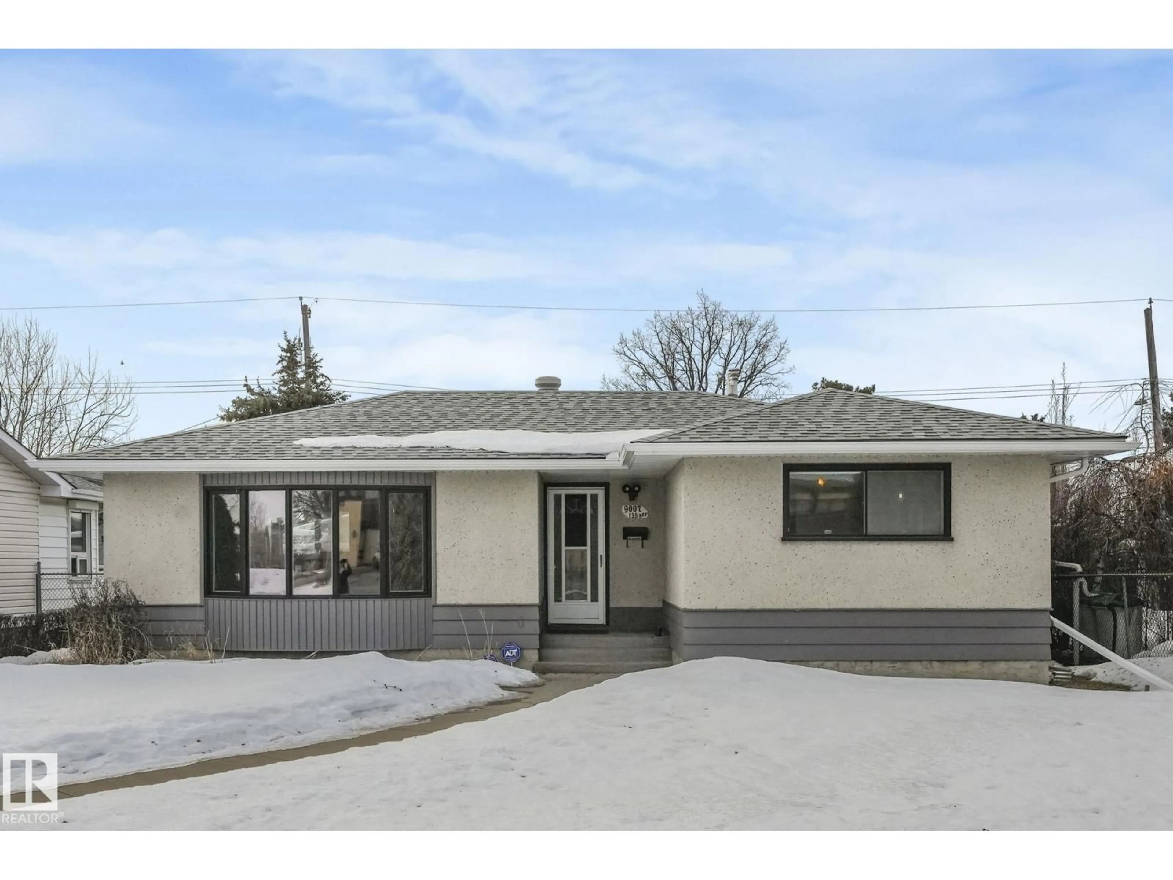 Home with vinyl exterior material, street for 9007 135 AV NW, Edmonton Alberta T5E1N5