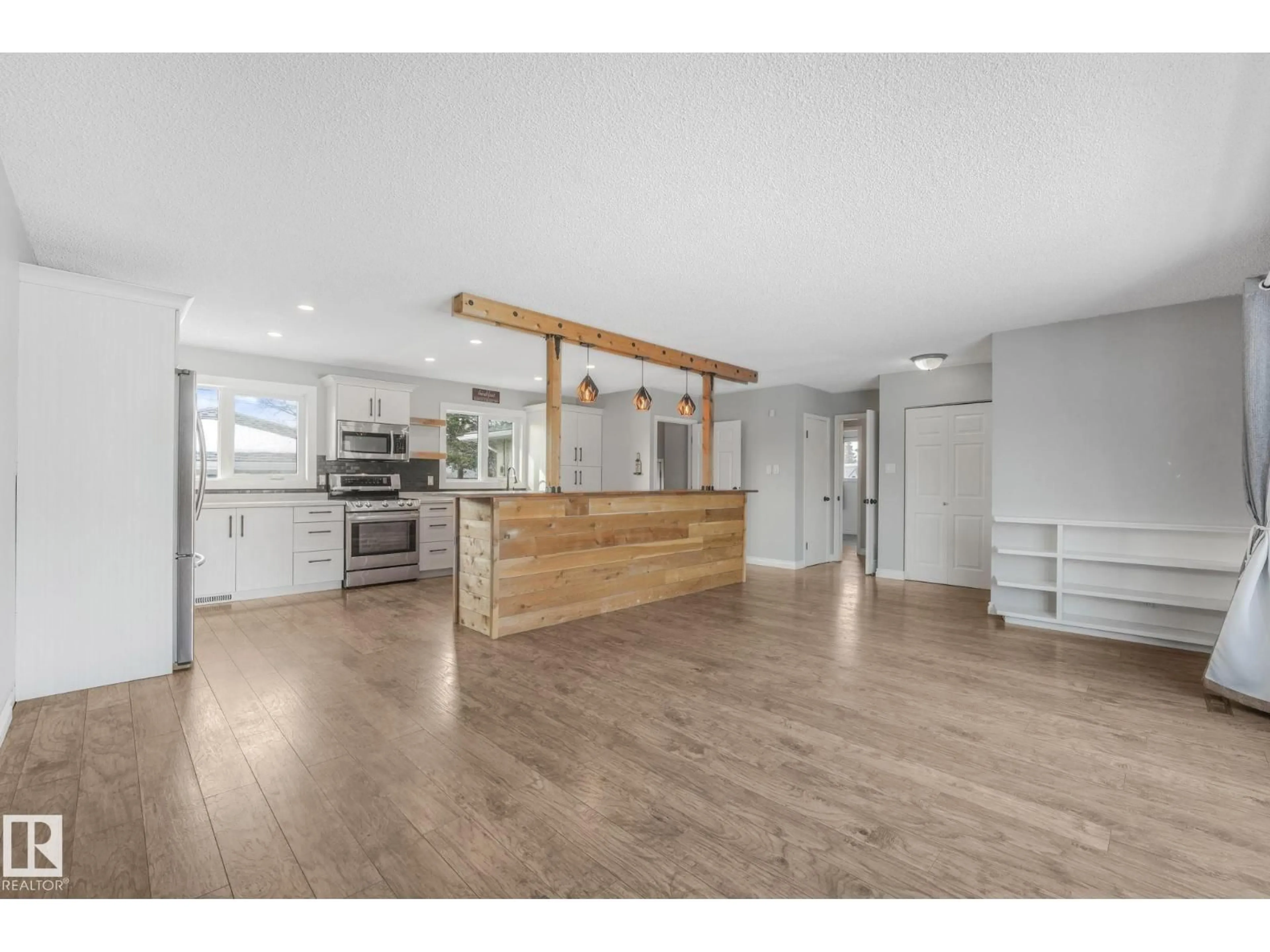 Open concept kitchen, wood/laminate floor for 9007 135 AV NW, Edmonton Alberta T5E1N5