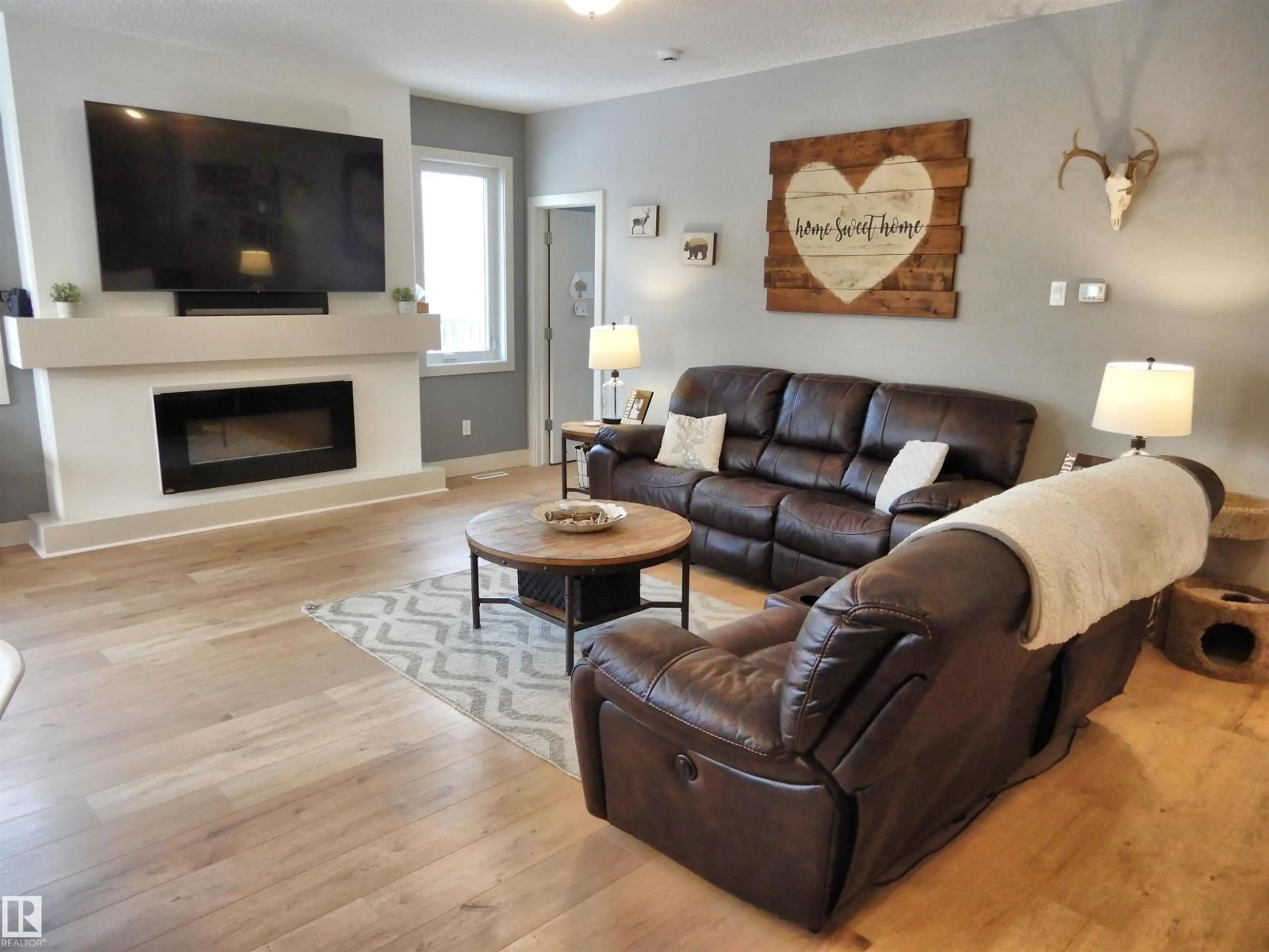 Living room with furniture, wood/laminate floor for 55108 - 210 RGE ROAD 15, Rural Lac Ste. Anne County Alberta T0E1V0