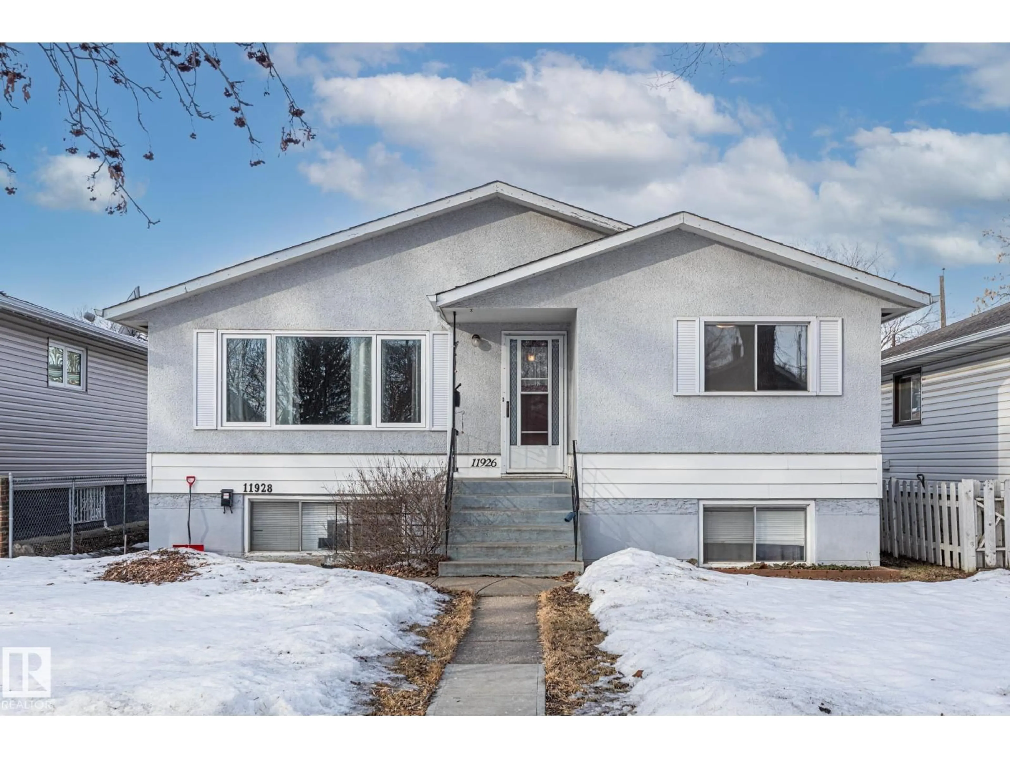 Home with vinyl exterior material, street for NW - 11926/11928 56 ST, Edmonton Alberta T5W3S9