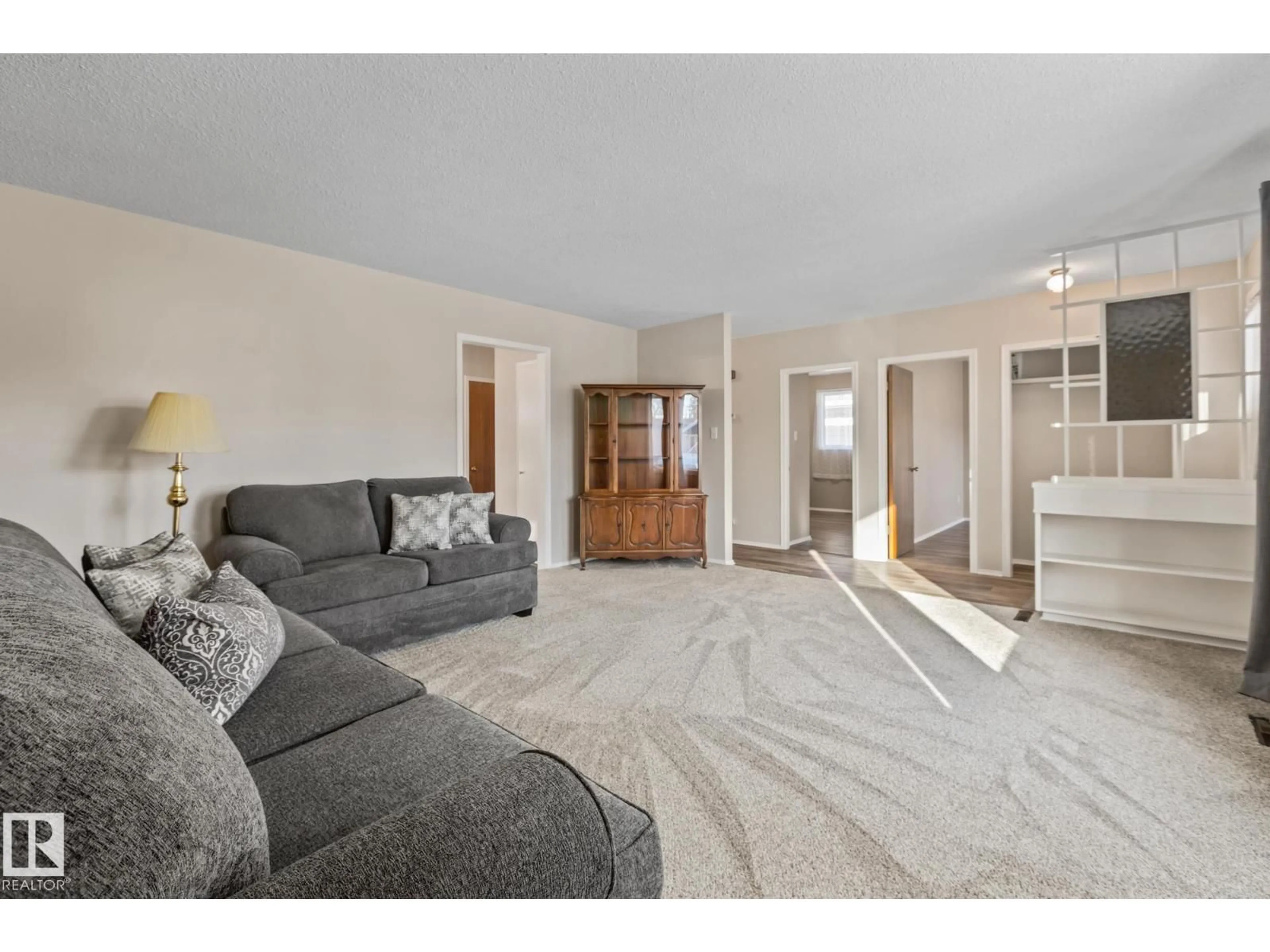 Living room with furniture, carpet floor for NW - 11926/11928 56 ST, Edmonton Alberta T5W3S9