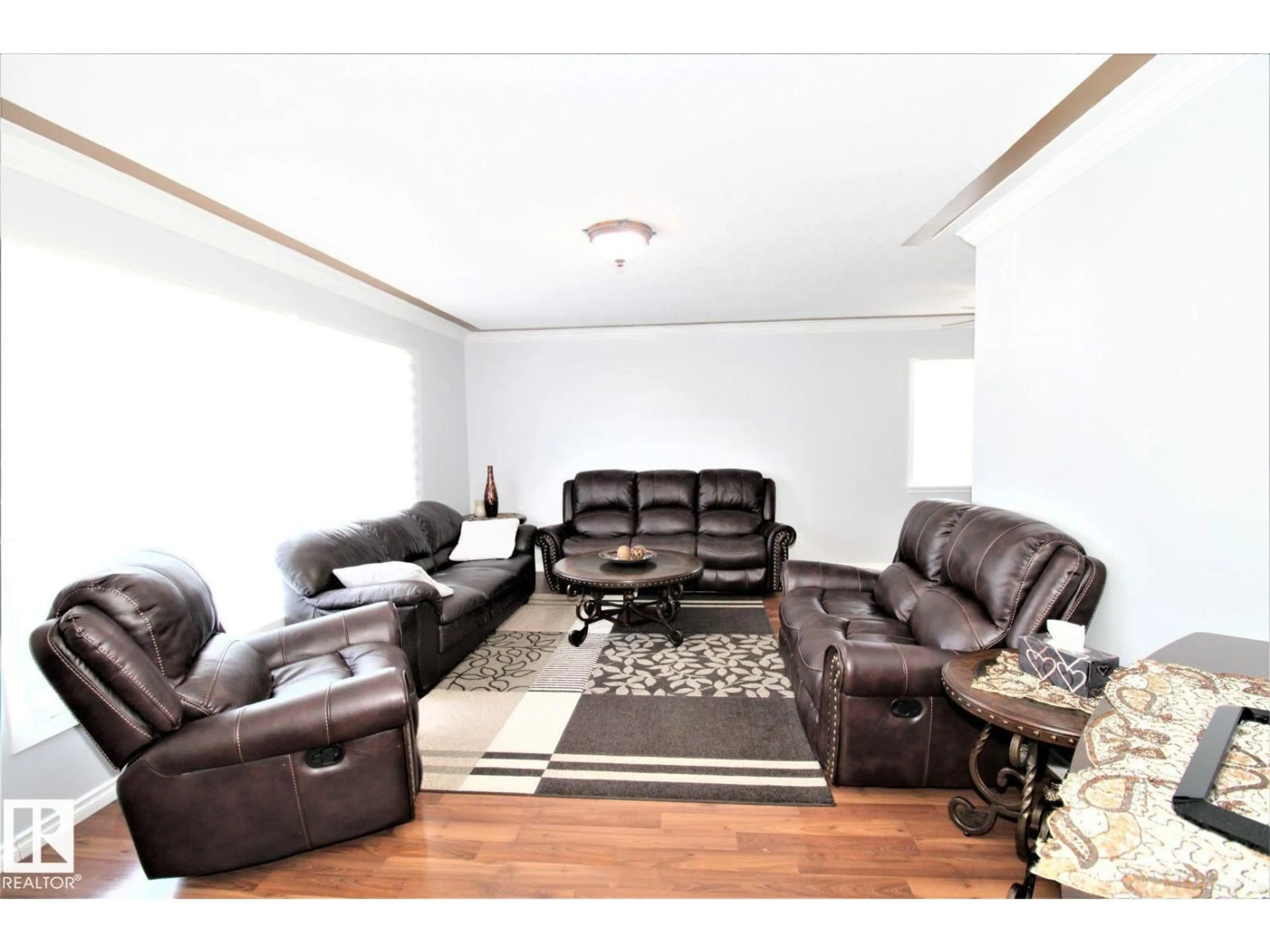 Living room with furniture, wood/laminate floor for 12111 137 AV, Edmonton Alberta T5L4C1