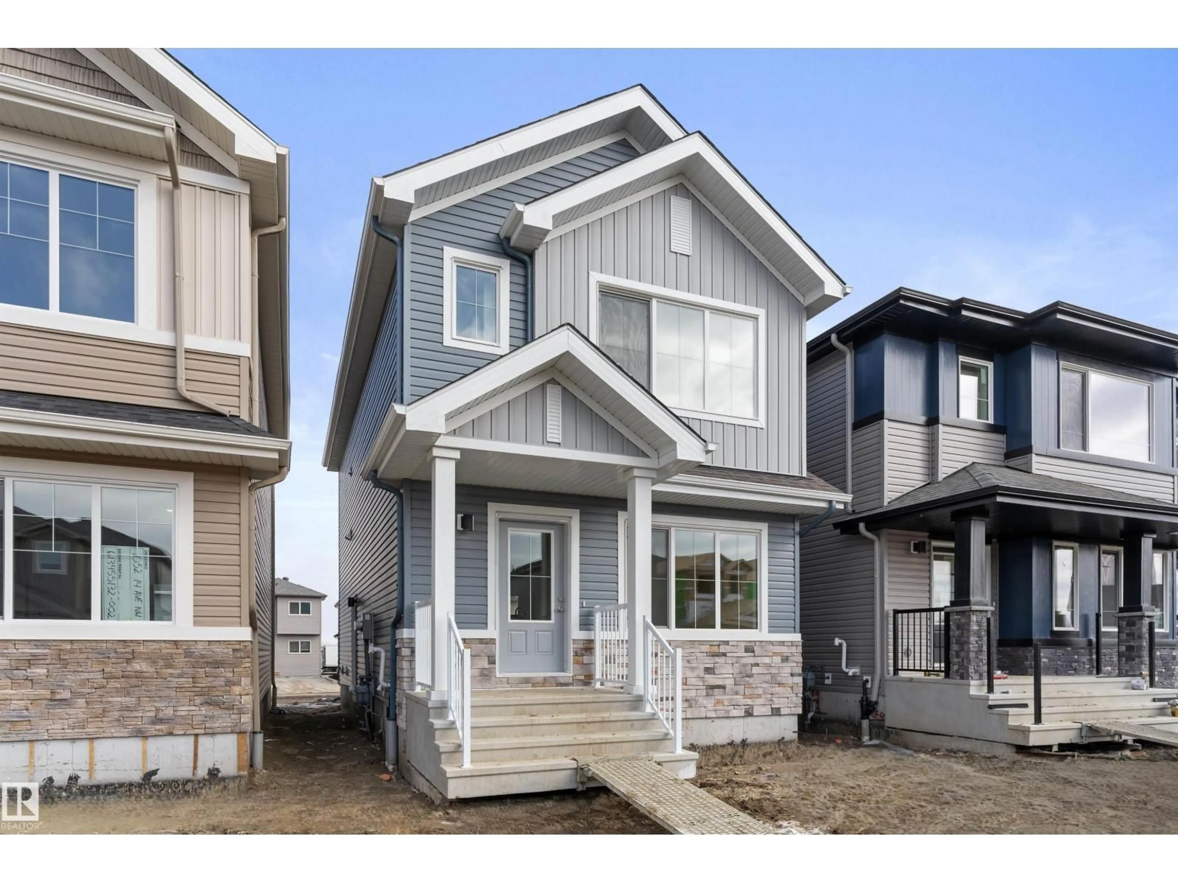 Home with vinyl exterior material, street for 1048 14 AV, Edmonton Alberta T6T2W7