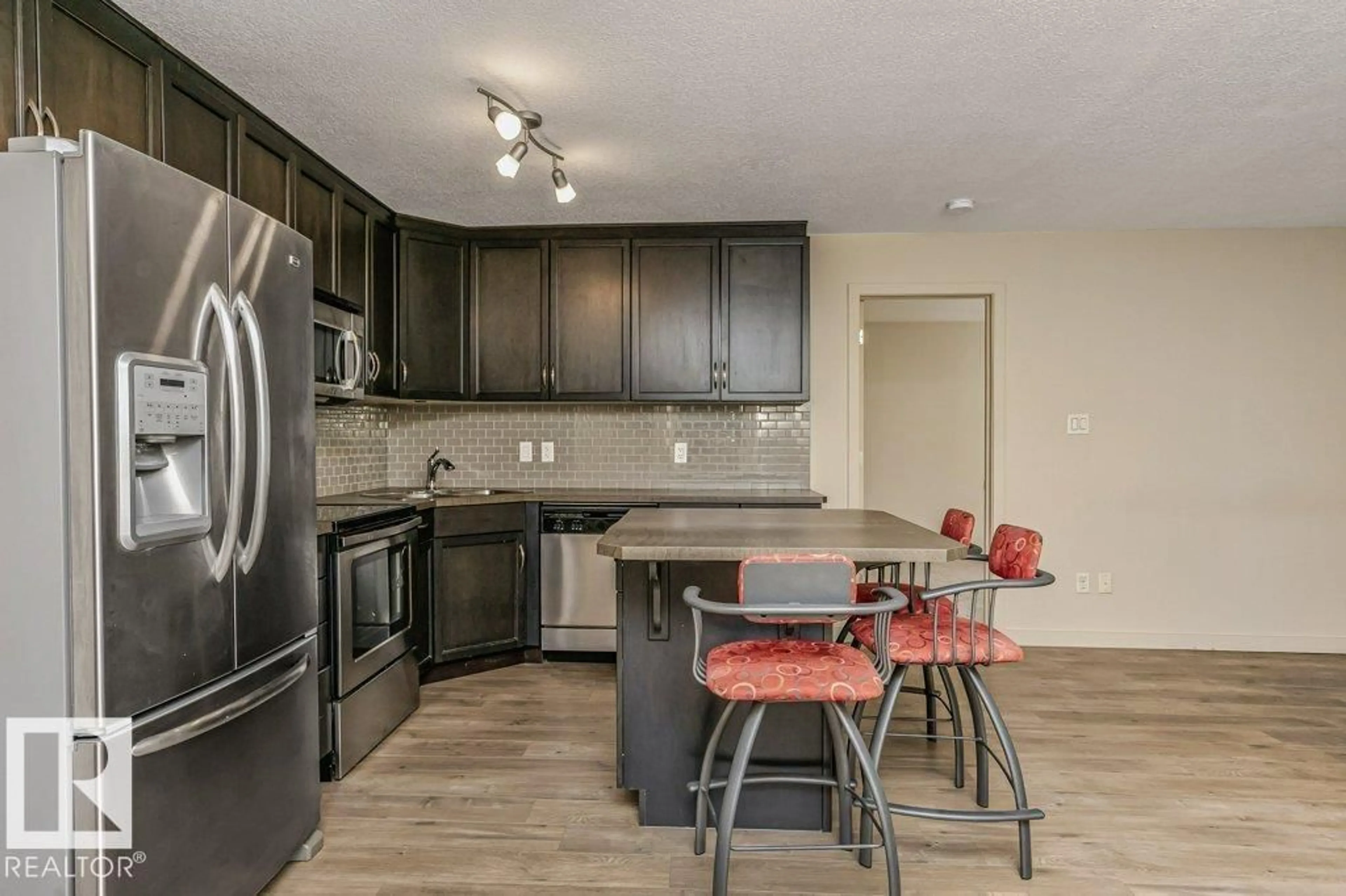 Open concept kitchen, wood/laminate floor for #163 - 11517 ELLERSLIE RD, Edmonton Alberta T6W2A9