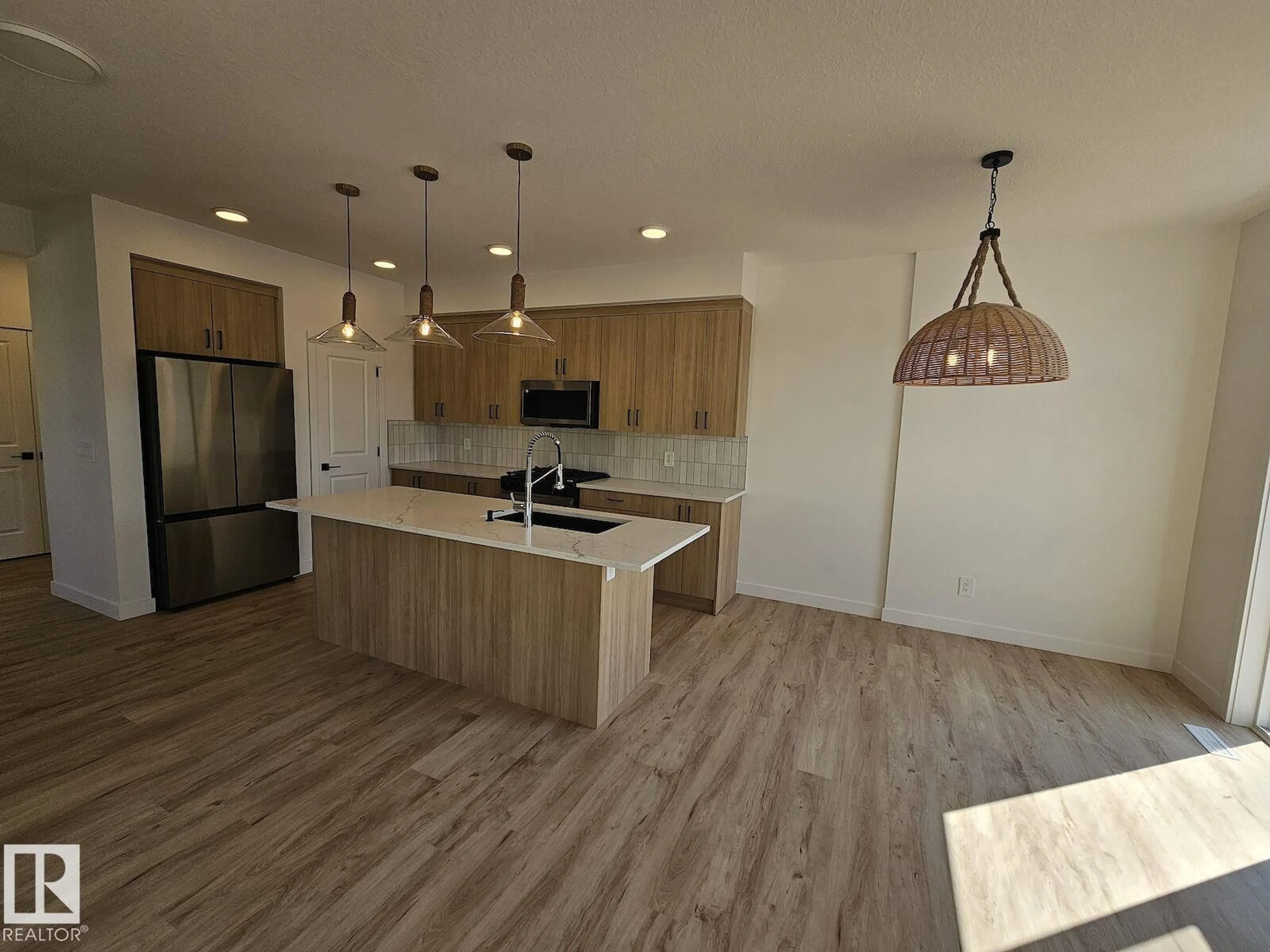 Open concept kitchen, wood/laminate floor for SW - 3332 168 ST, Edmonton Alberta T6W5M2