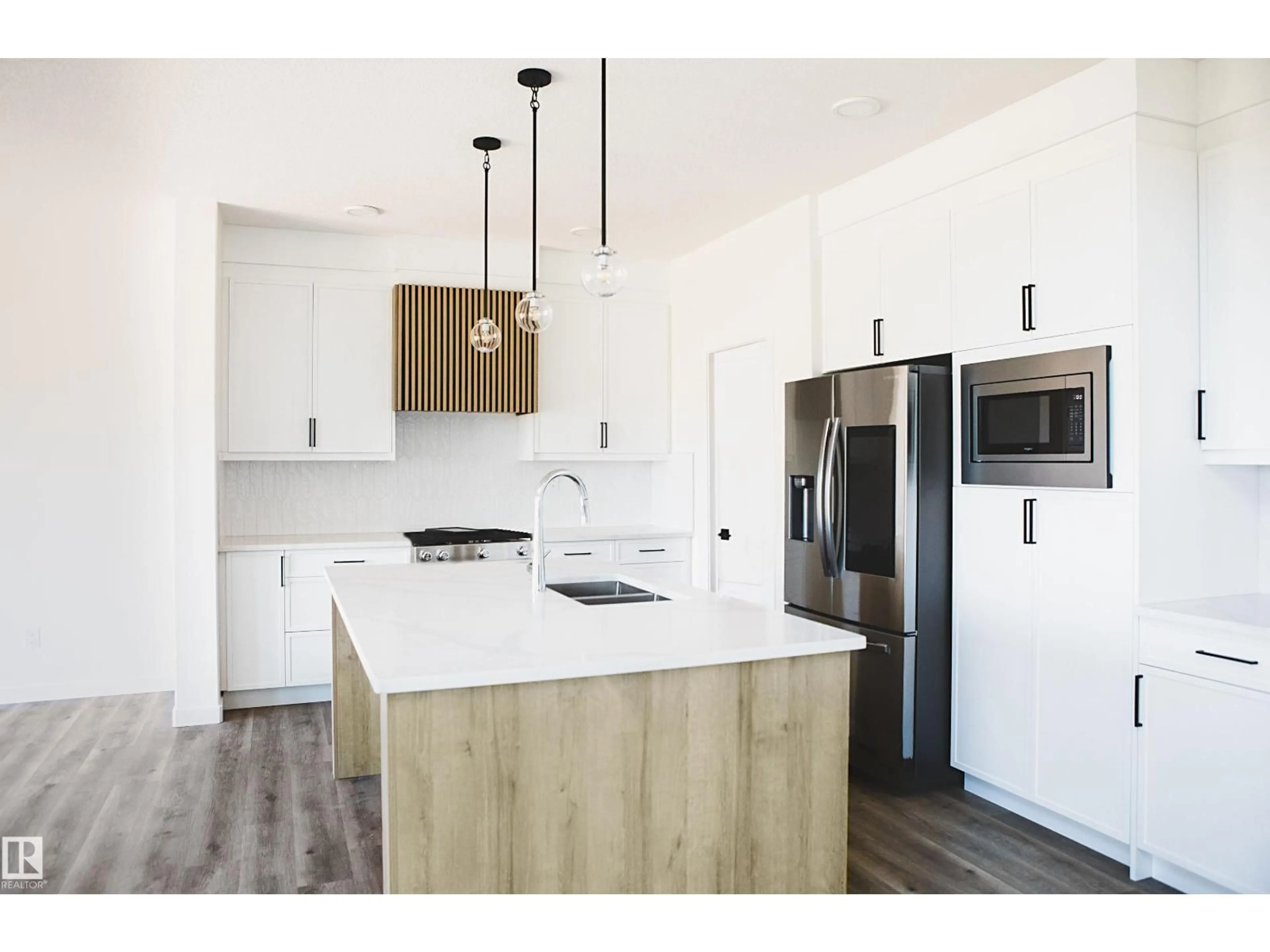 Open concept kitchen, wood/laminate floor for 167 STARLING WAY, Fort Saskatchewan Alberta T8L1X5