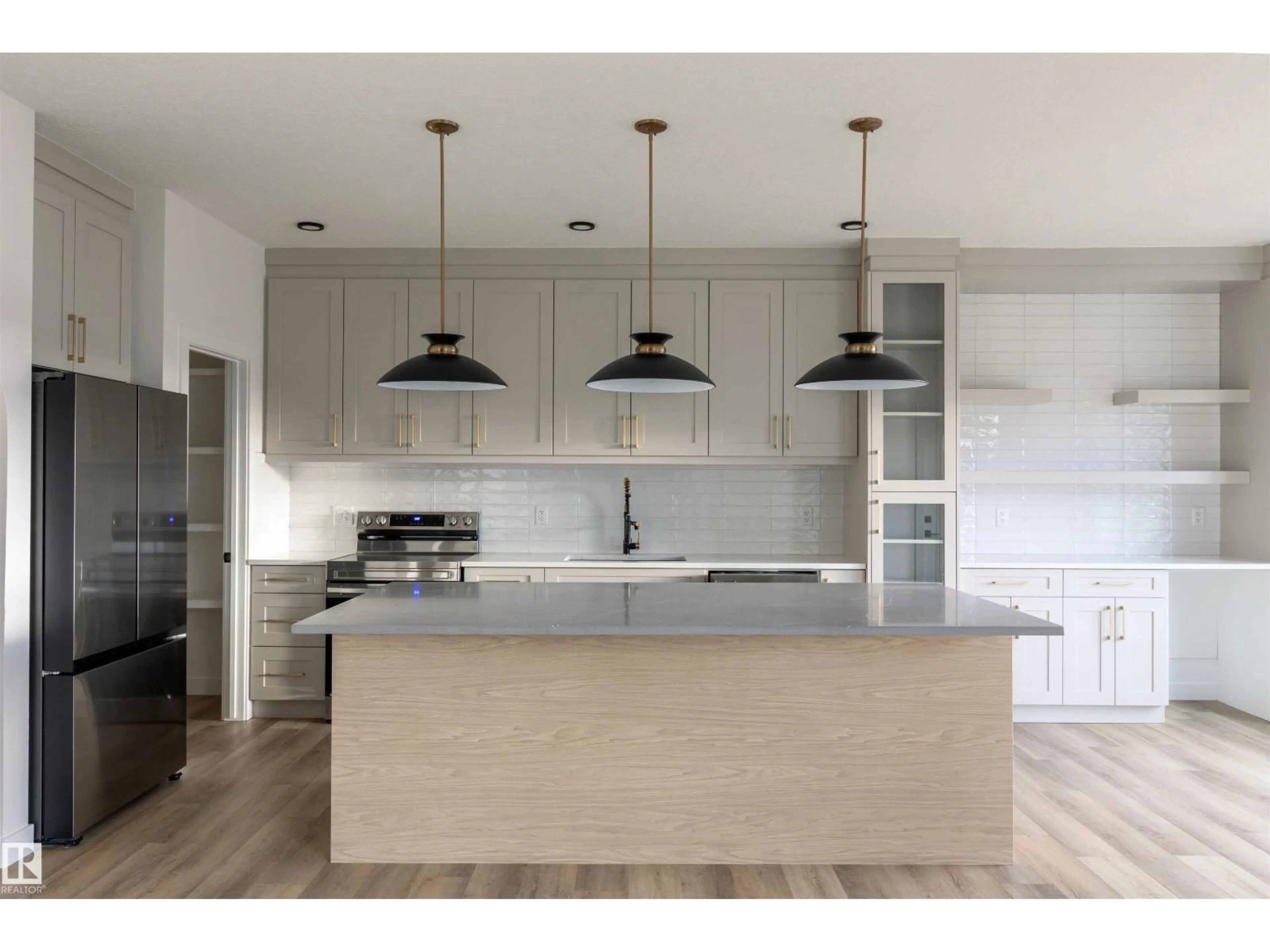 Open concept kitchen, wood/laminate floor for 163 STARLING WAY, Fort Saskatchewan Alberta T8L1X5