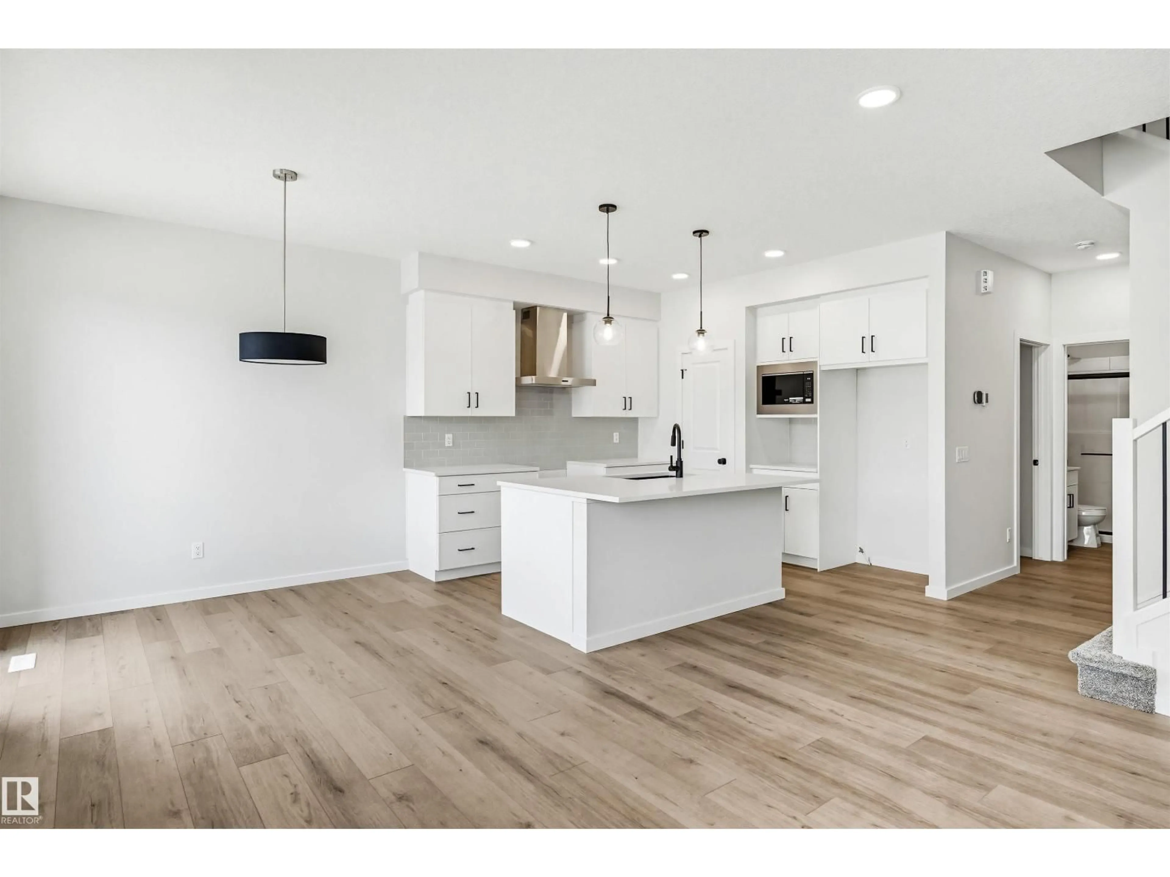 Open concept kitchen, wood/laminate floor for 17351 3 ST, Edmonton Alberta T5Y4G7