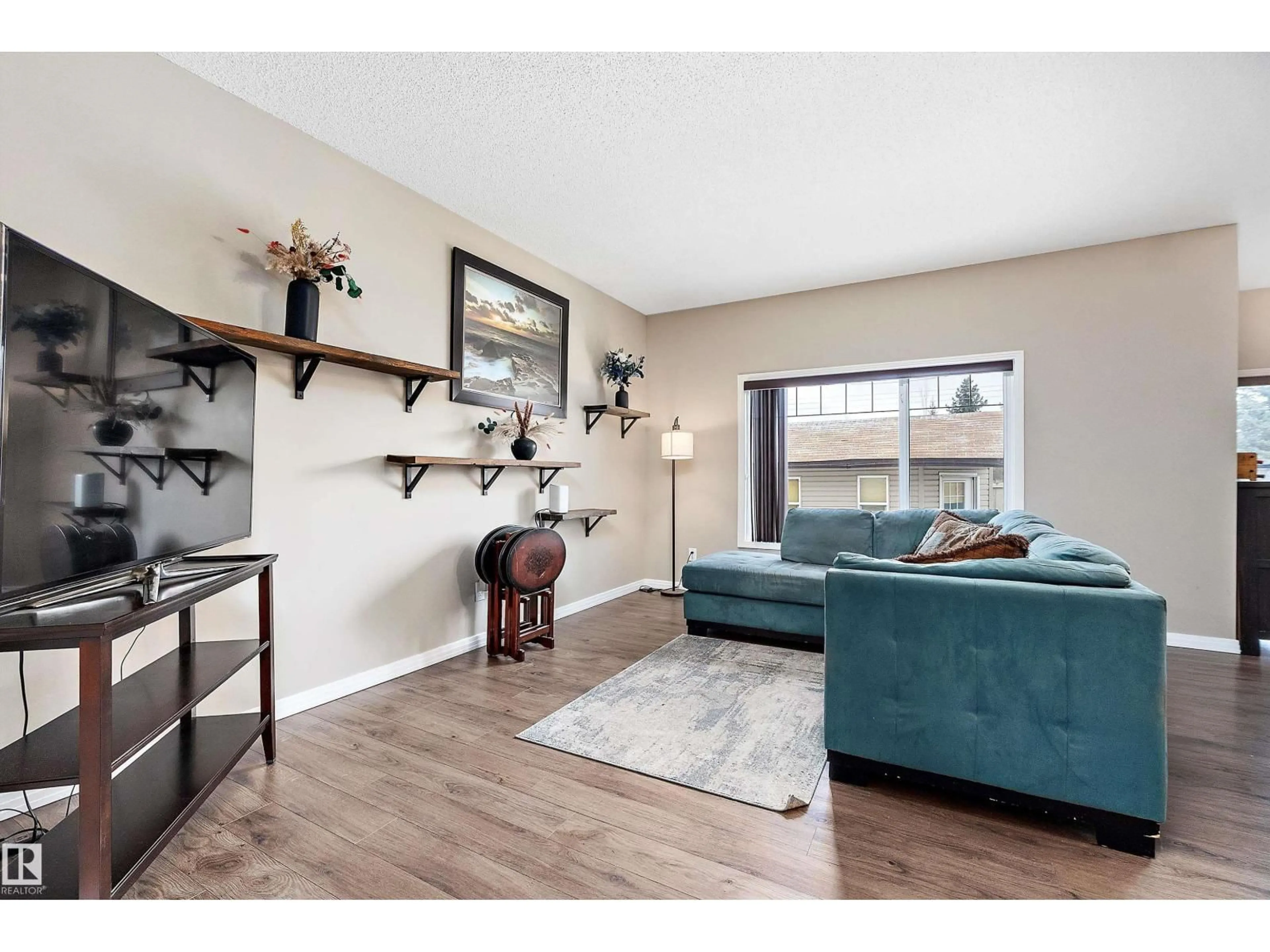 Living room with furniture, wood/laminate floor for 33 SUTHERLAND ST, Leduc Alberta T9E8R6