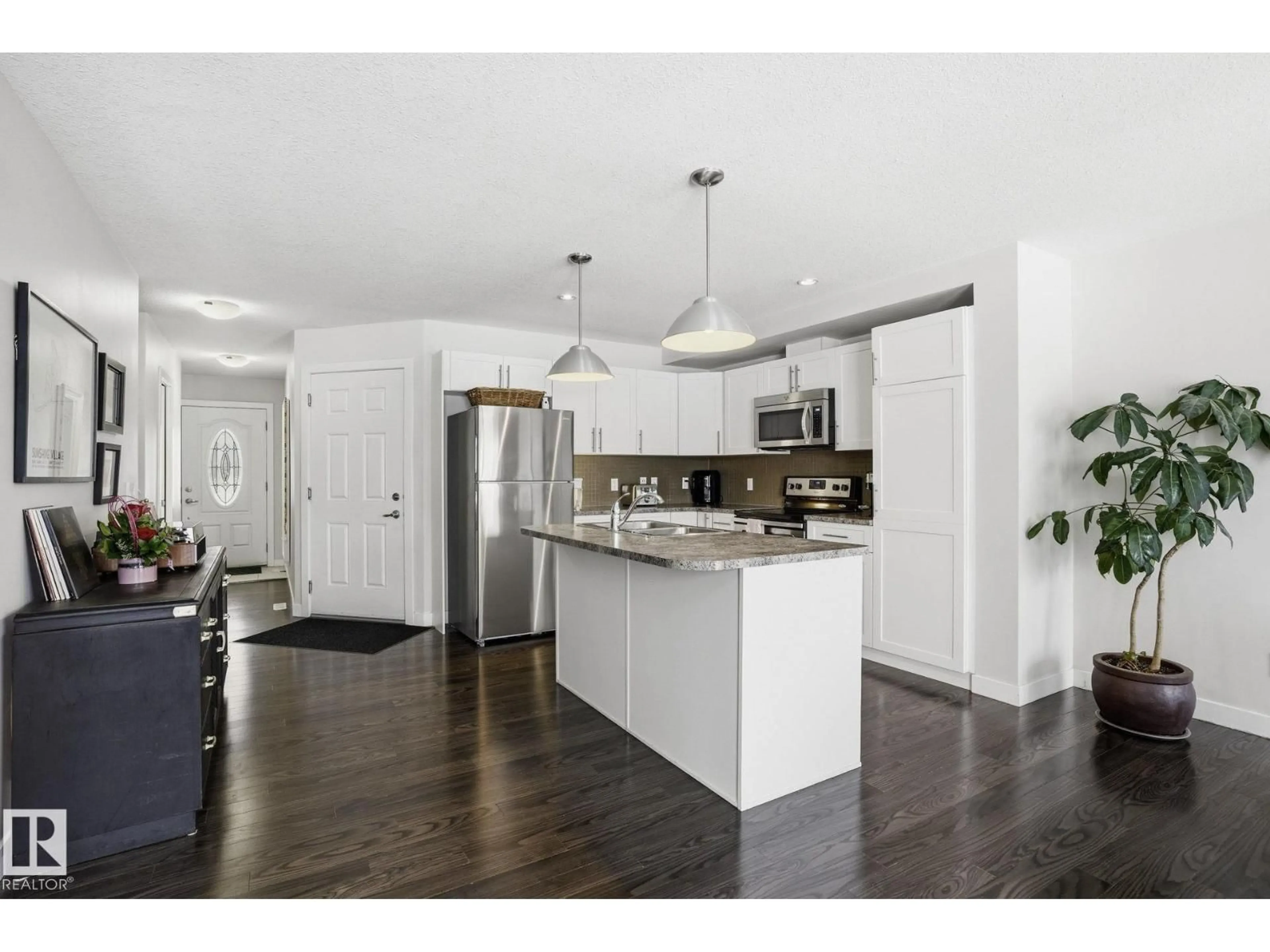 Open concept kitchen, wood/laminate floor for 500 - 27 GROVE DR, Spruce Grove Alberta T7X0P6