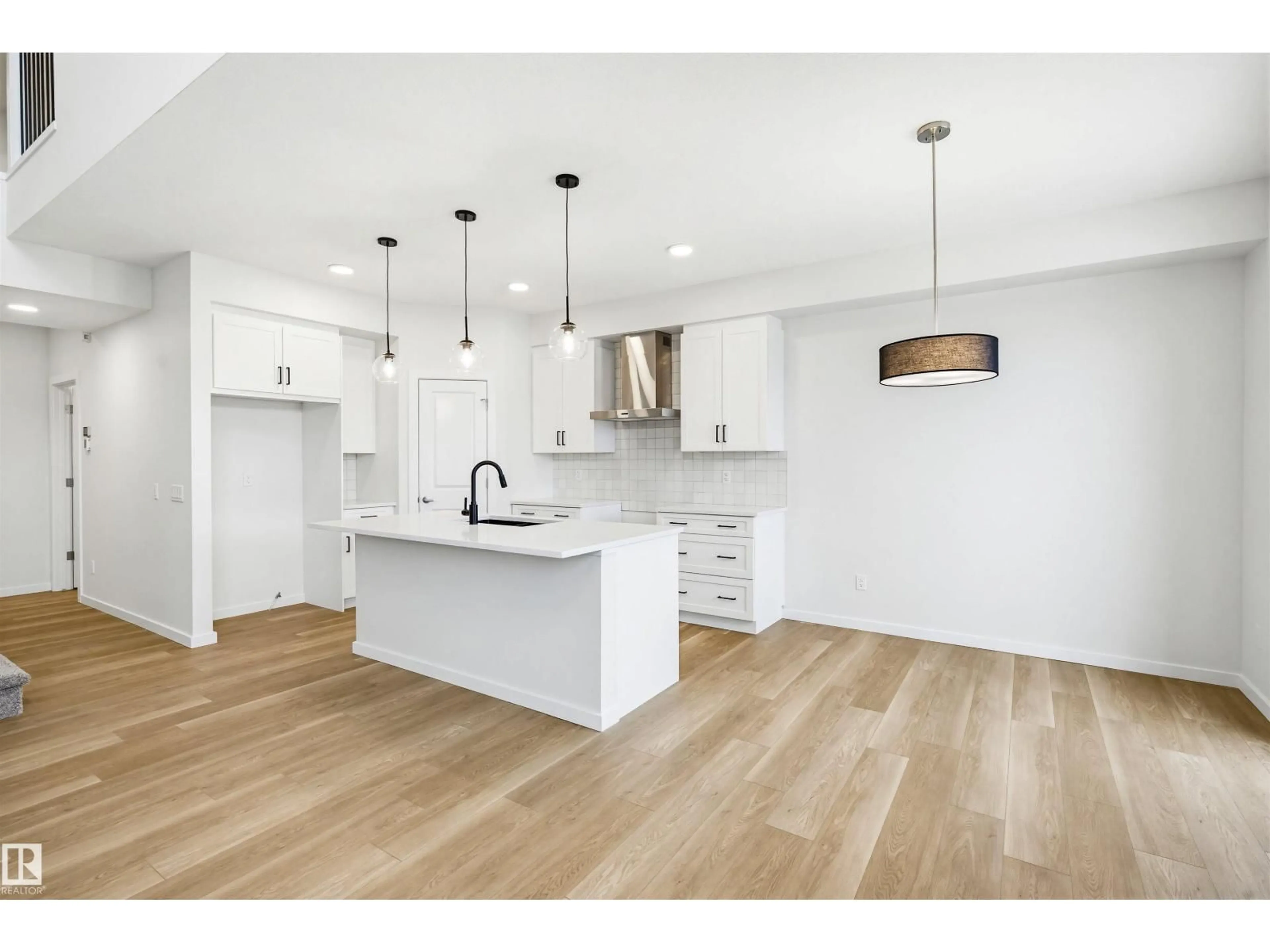 Open concept kitchen, wood/laminate floor for 5107 69 ST, Beaumont Alberta T4X3E4