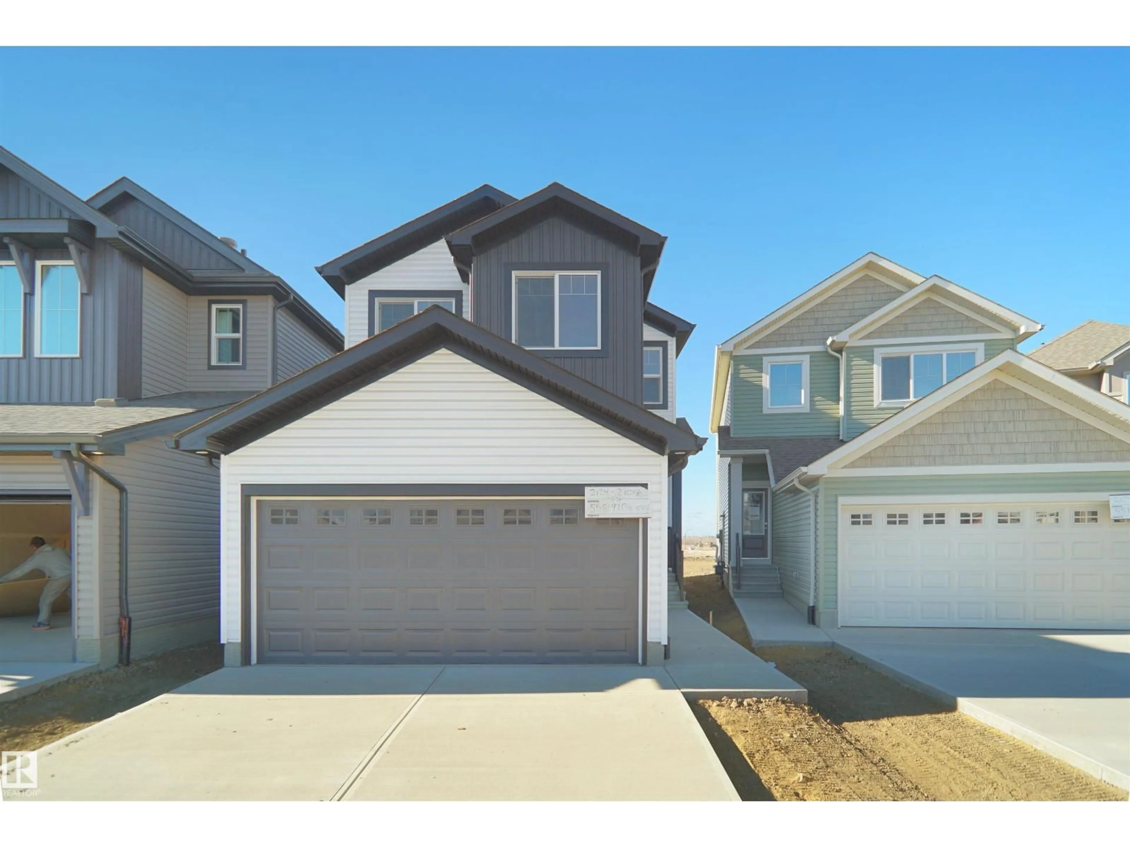 Home with vinyl exterior material, street for NW - 2124 210 ST, Edmonton Alberta T6M1P7