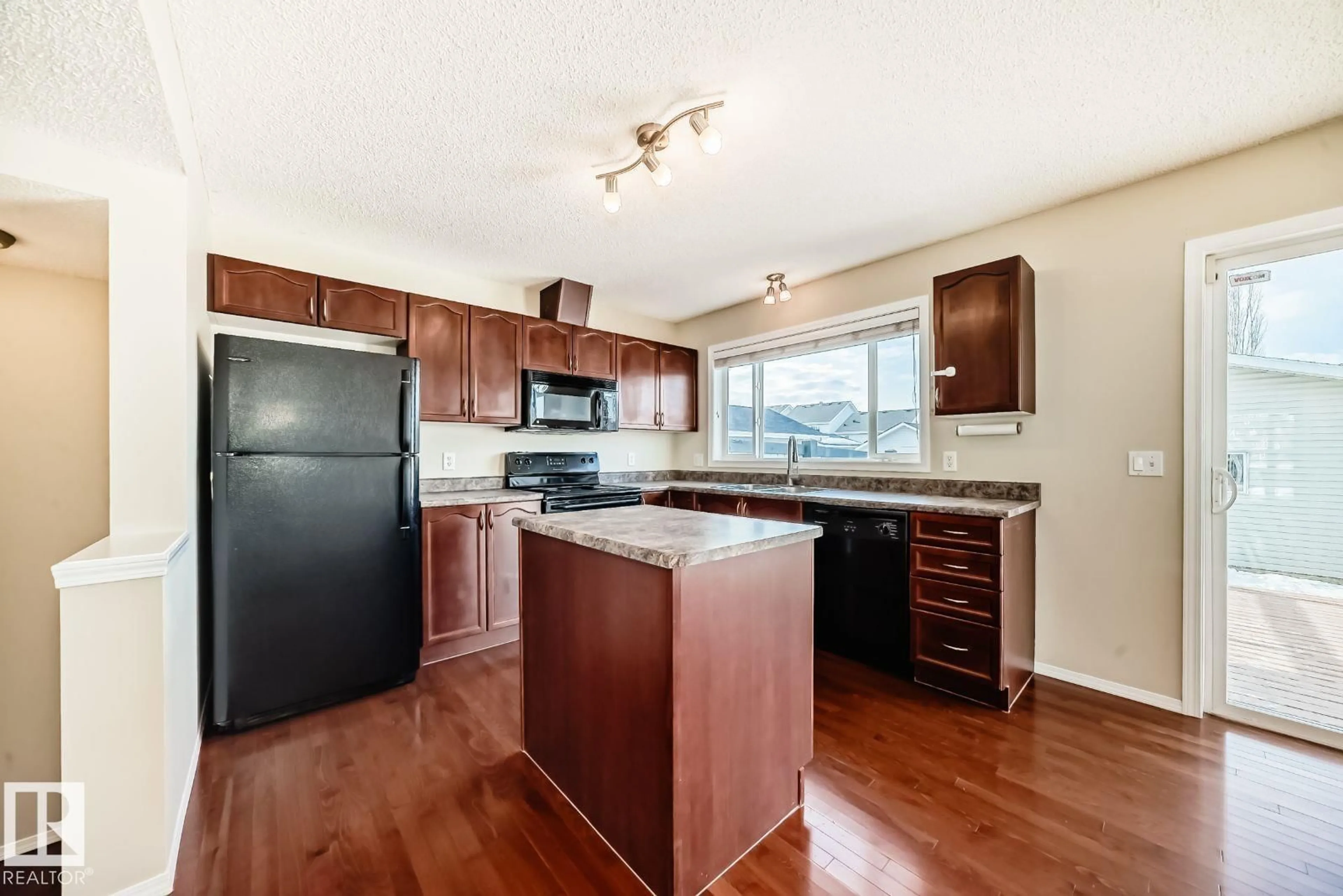 Open concept kitchen, wood/laminate floor for 1412 75 ST, Edmonton Alberta T6X0C7
