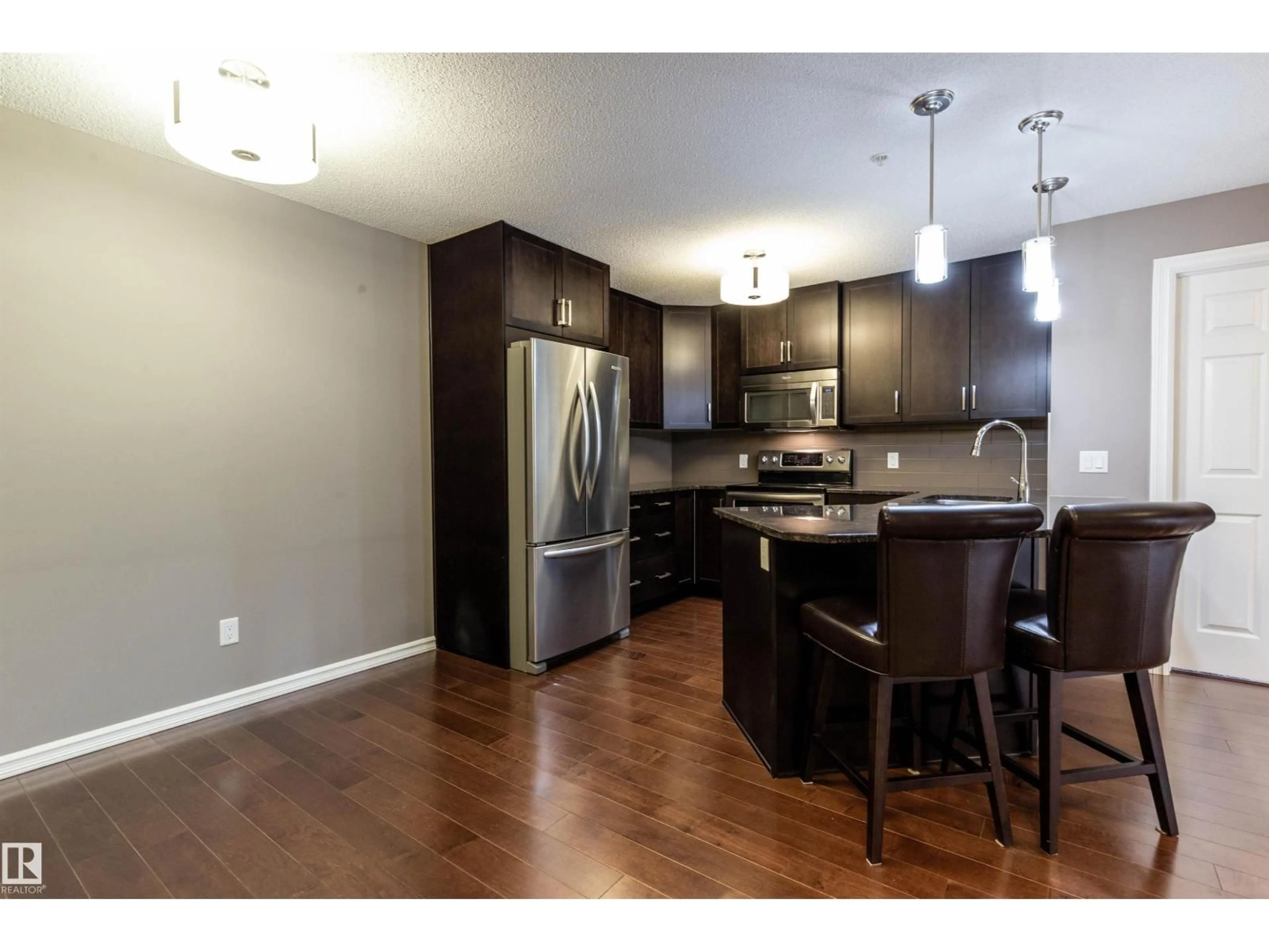 Open concept kitchen, wood/laminate floor for 307 - 2203 44 AV, Edmonton Alberta T6T0T1