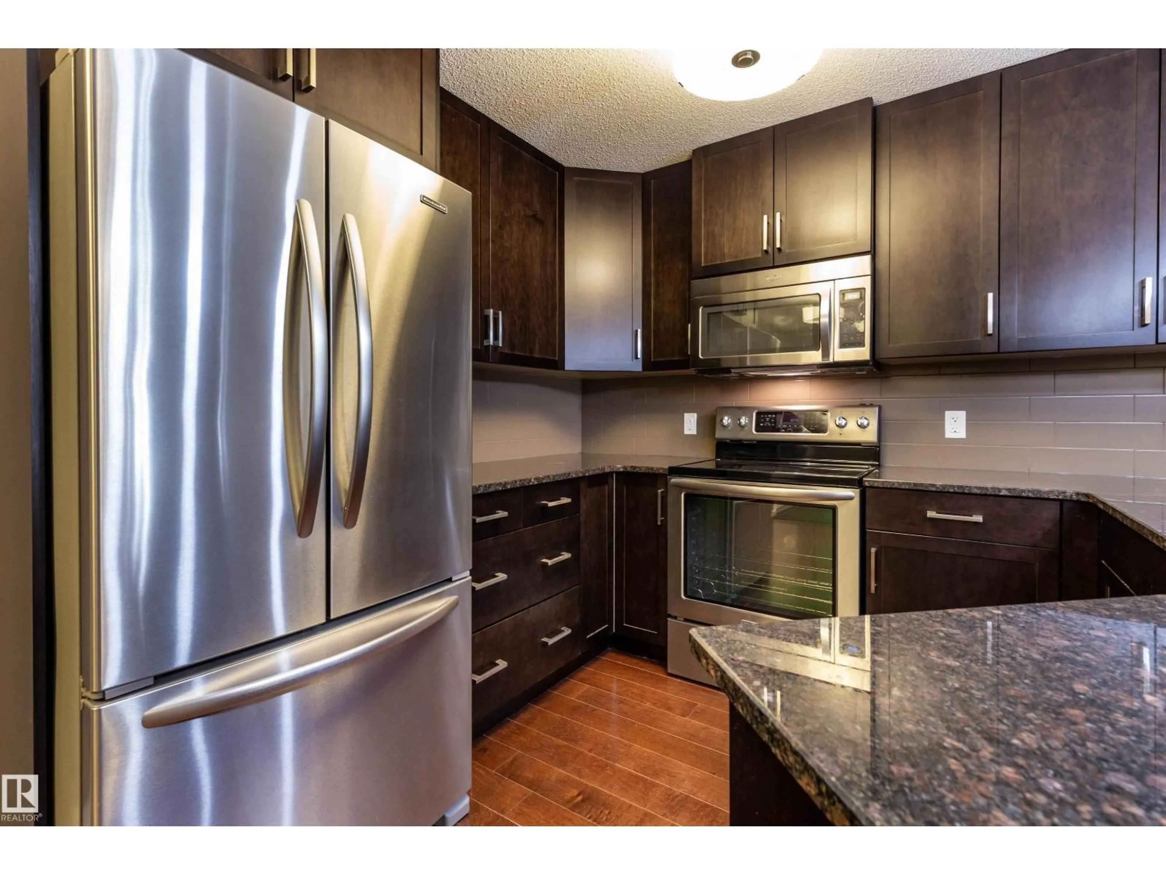 Open concept kitchen, wood/laminate floor for 307 - 2203 44 AV, Edmonton Alberta T6T0T1