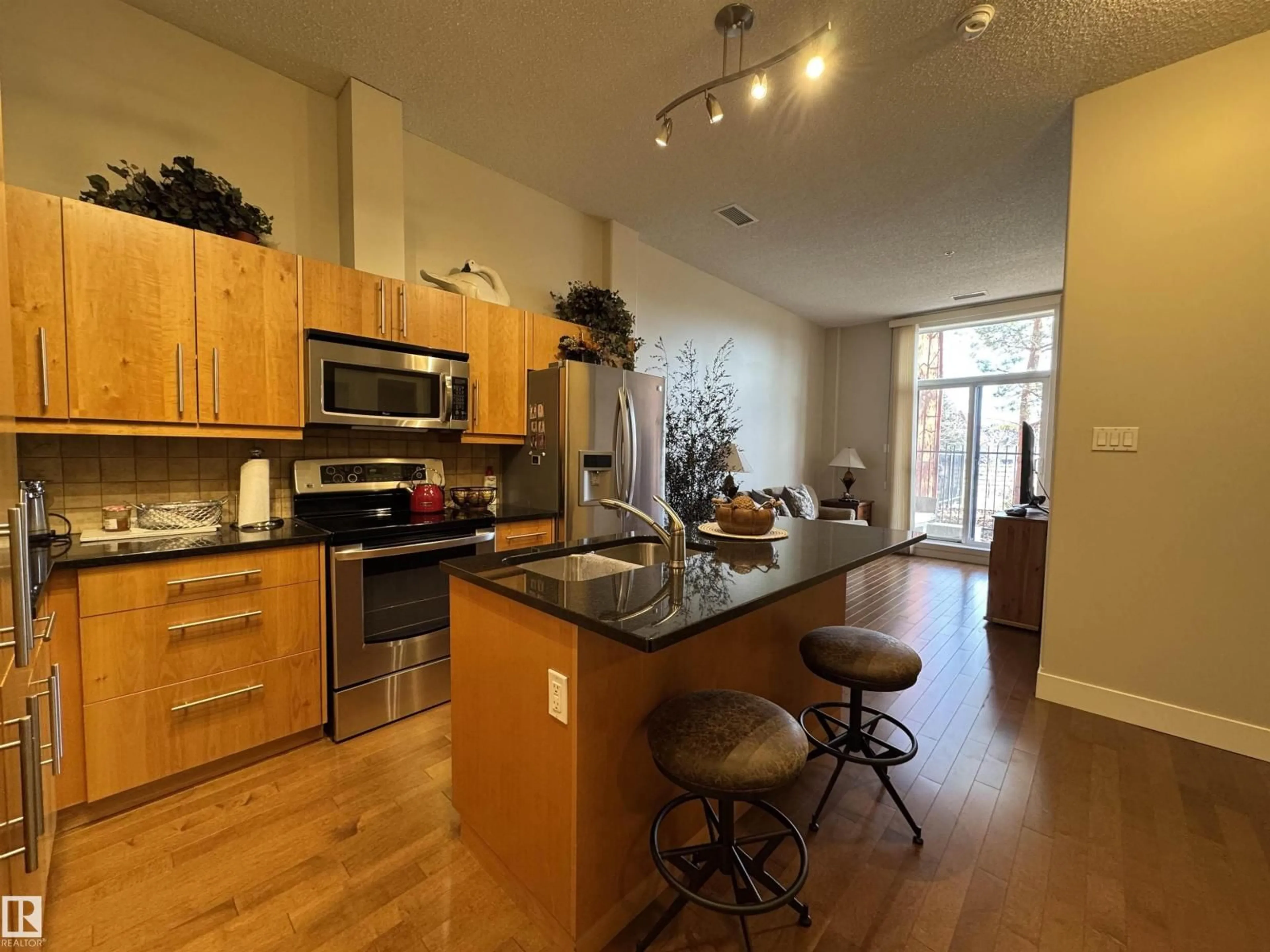 Open concept kitchen, wood/laminate floor for #115 - 6608 28 AV, Edmonton Alberta T6K2R1
