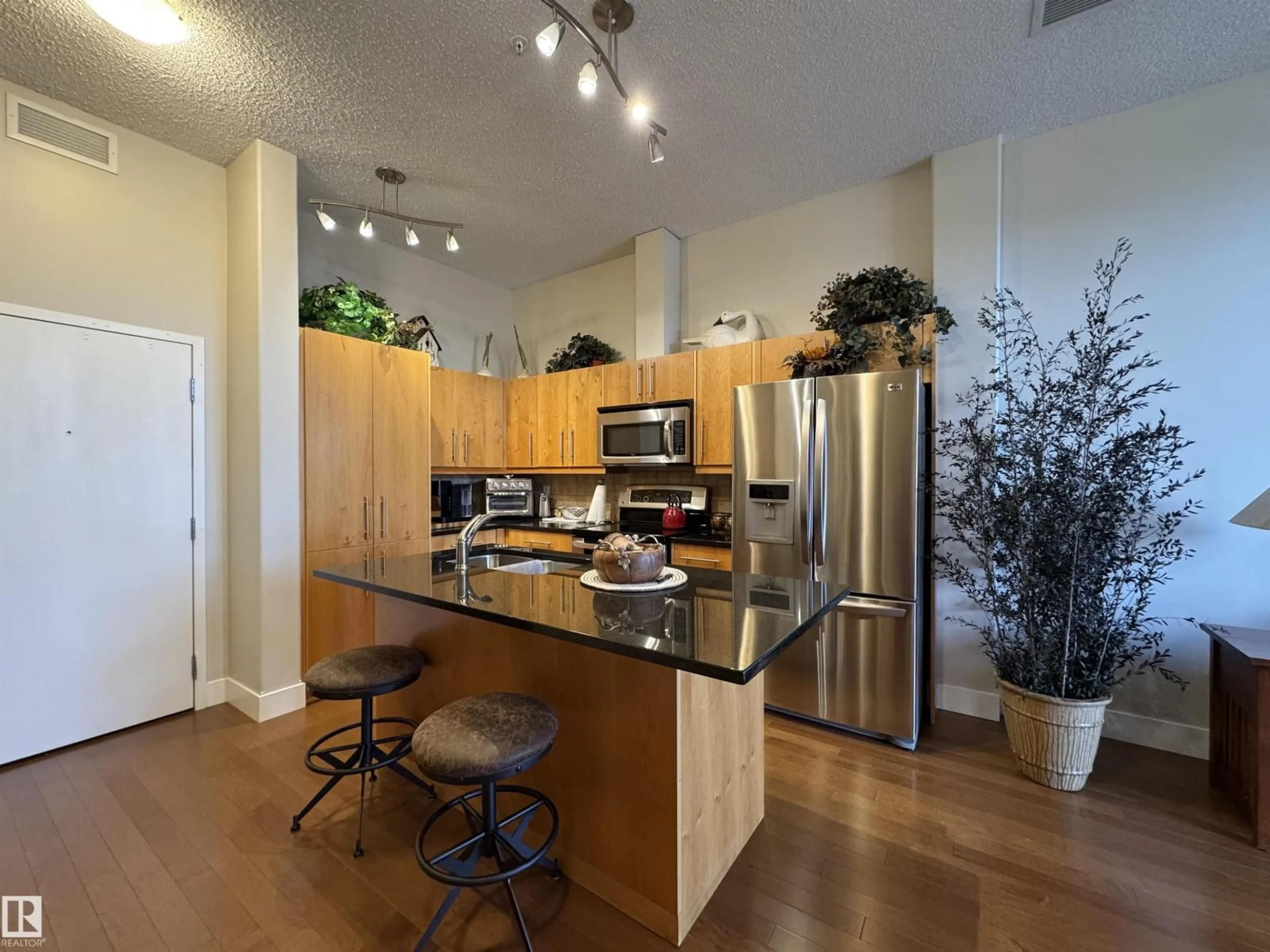 Open concept kitchen, wood/laminate floor for #115 - 6608 28 AV, Edmonton Alberta T6K2R1