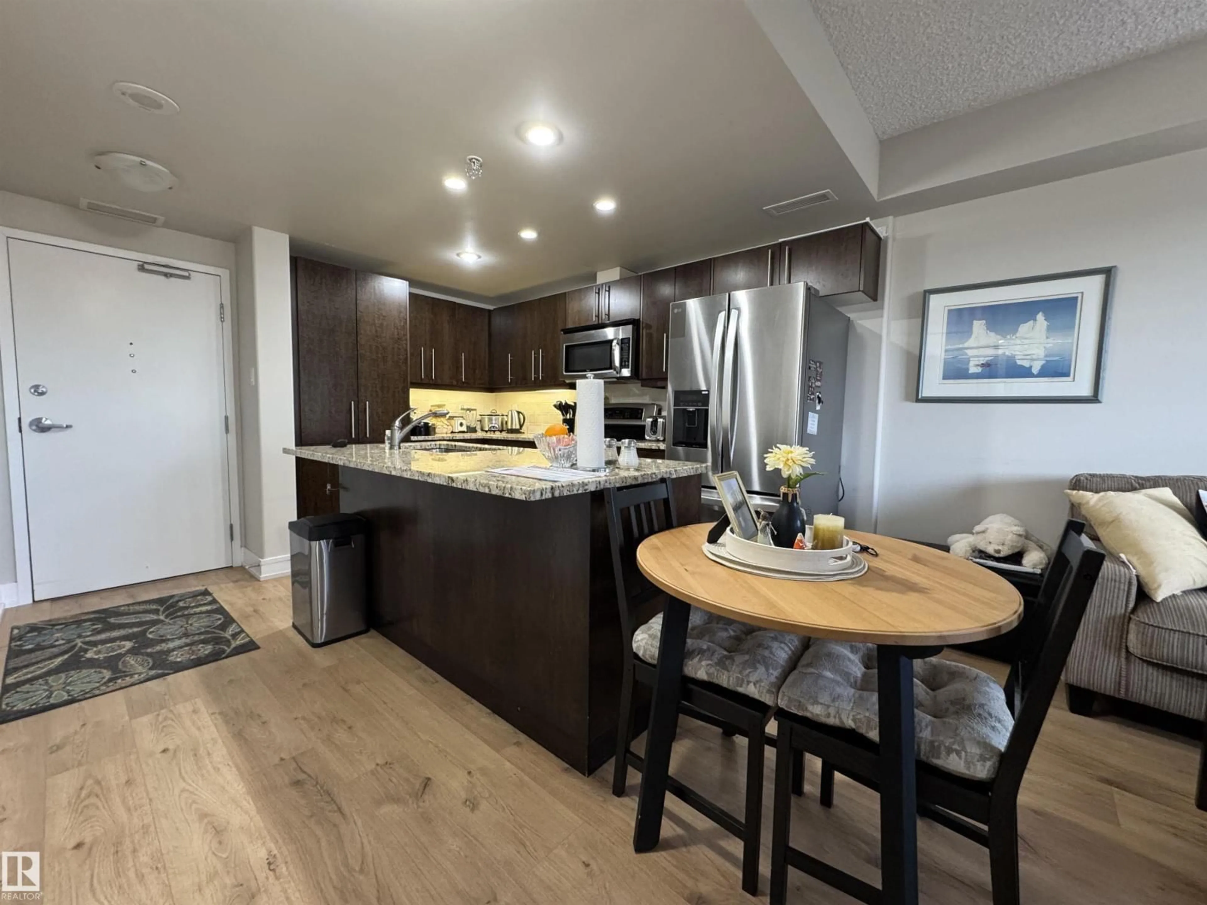 Open concept kitchen, wood/laminate floor for #218 - 6608 28 AV, Edmonton Alberta T6J2R1