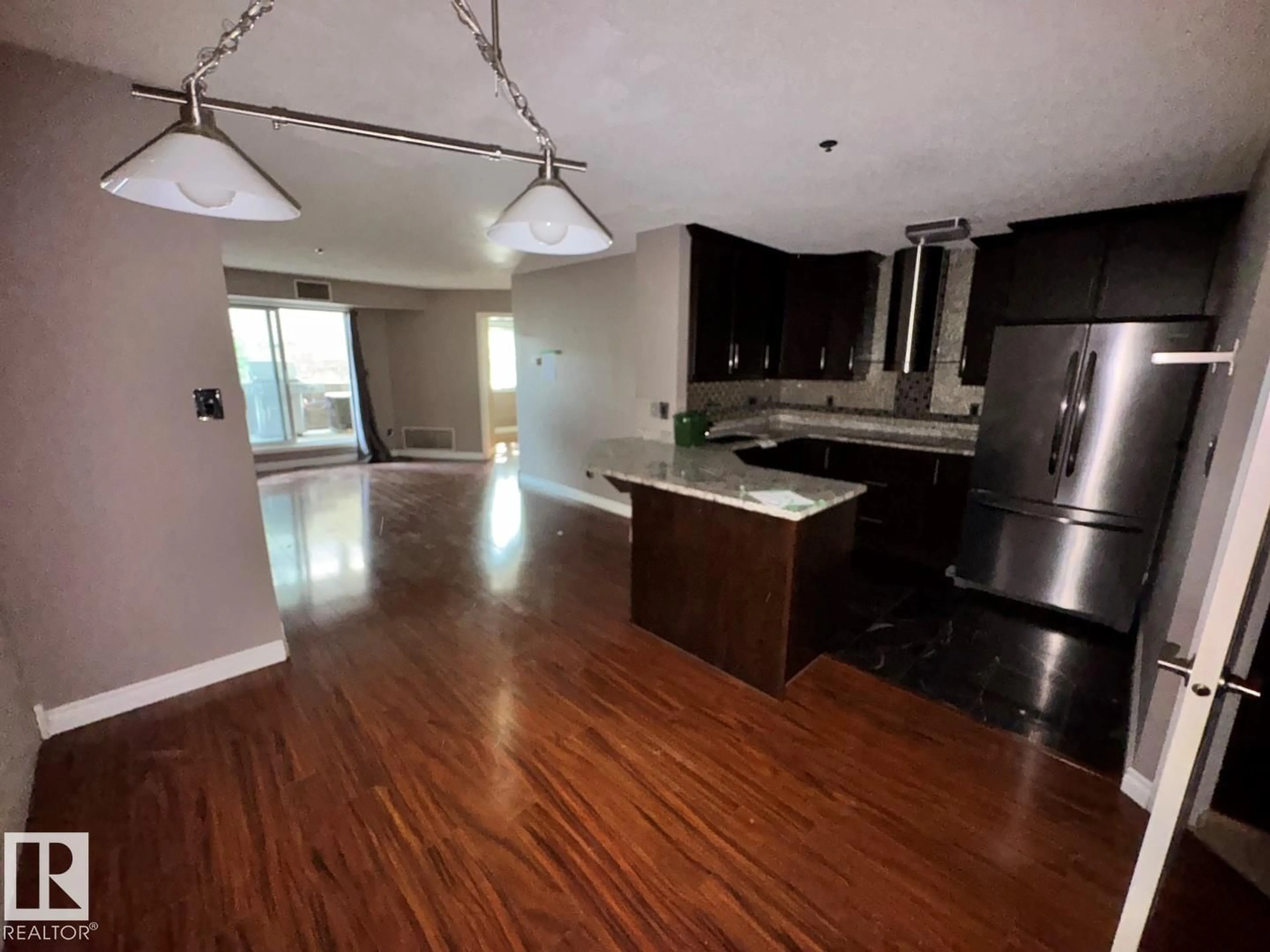 Open concept kitchen, wood/laminate floor for #103 - 9640 105 ST, Edmonton Alberta T5K1A4