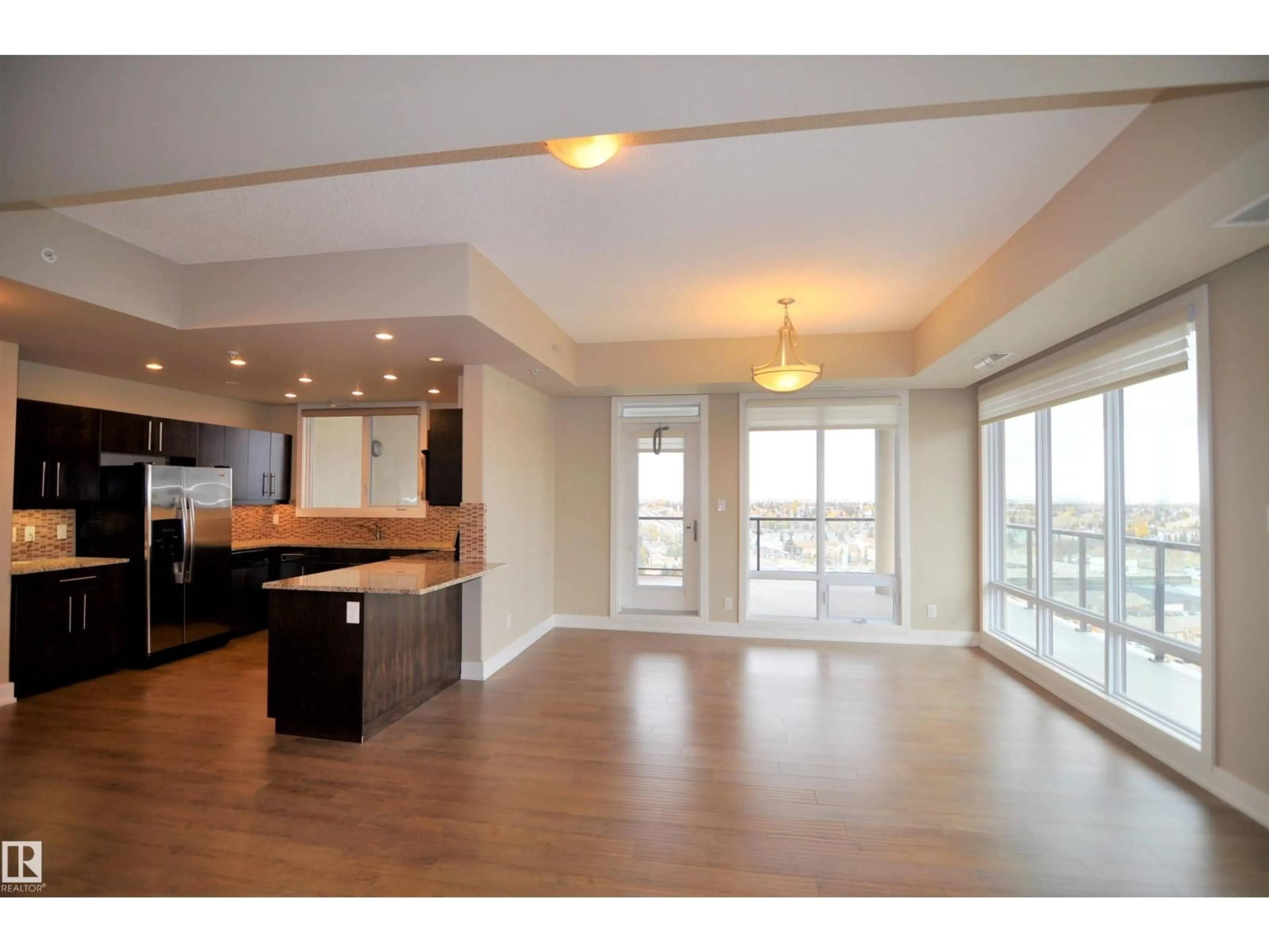 Open concept kitchen, wood/laminate floor for #1402 - 6608 28 AV, Edmonton Alberta T6J2R1