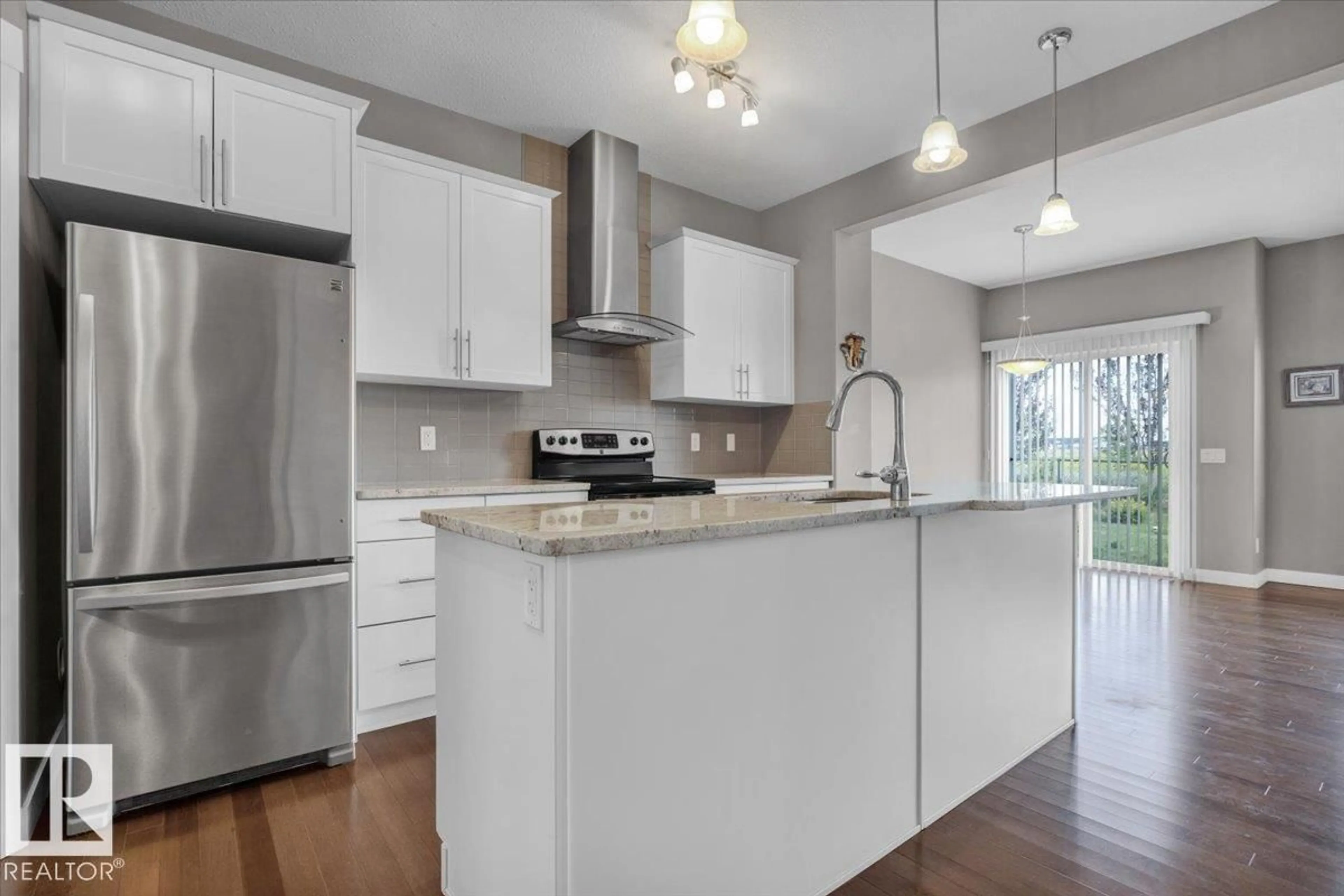 Open concept kitchen, wood/laminate floor for 7214 174 AV, Edmonton Alberta T5Z0L3