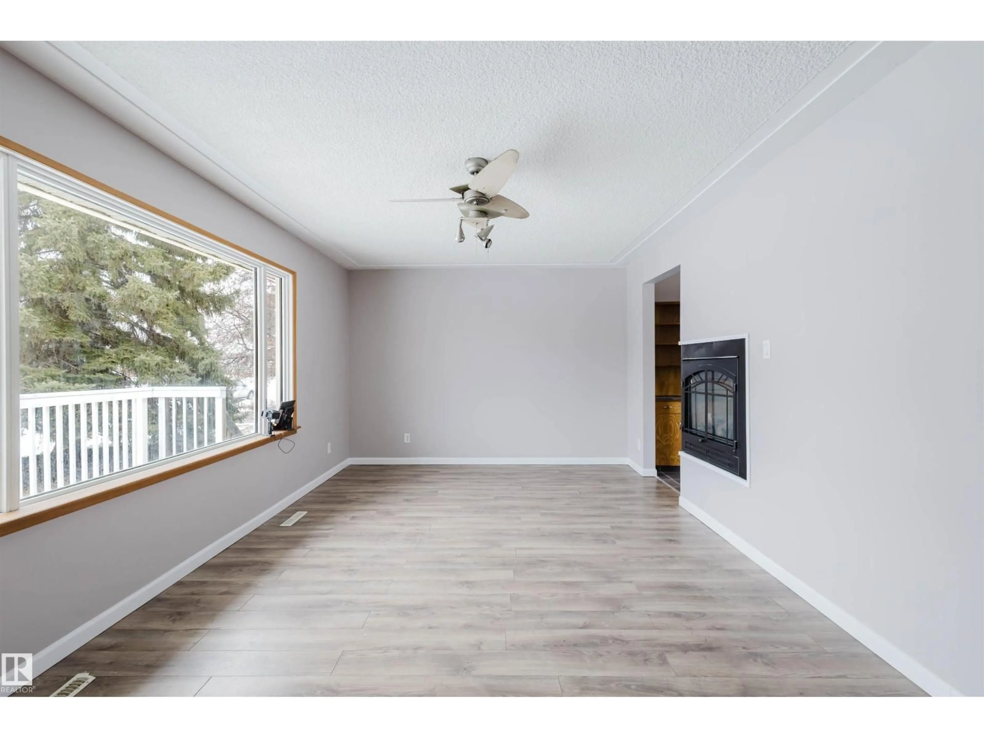 Living room with furniture, wood/laminate floor for 6048 105B STREET NW, Edmonton Alberta T6H2S5