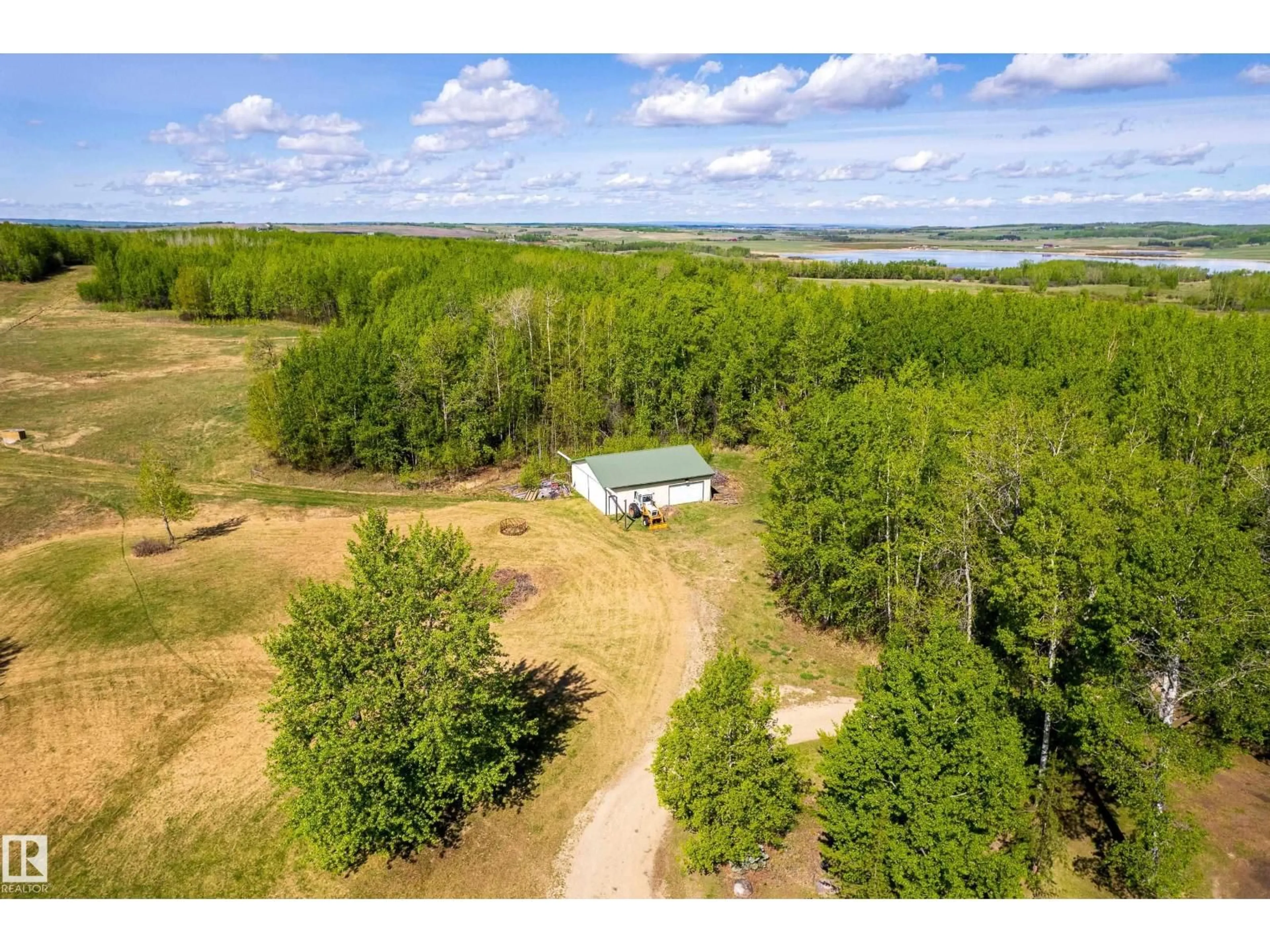 A pic from outside/outdoor area/front of a property/back of a property/a pic from drone, water/lake/river/ocean view for 6521 TWP RD 554, Rural Lac Ste. Anne County Alberta T0E2A0