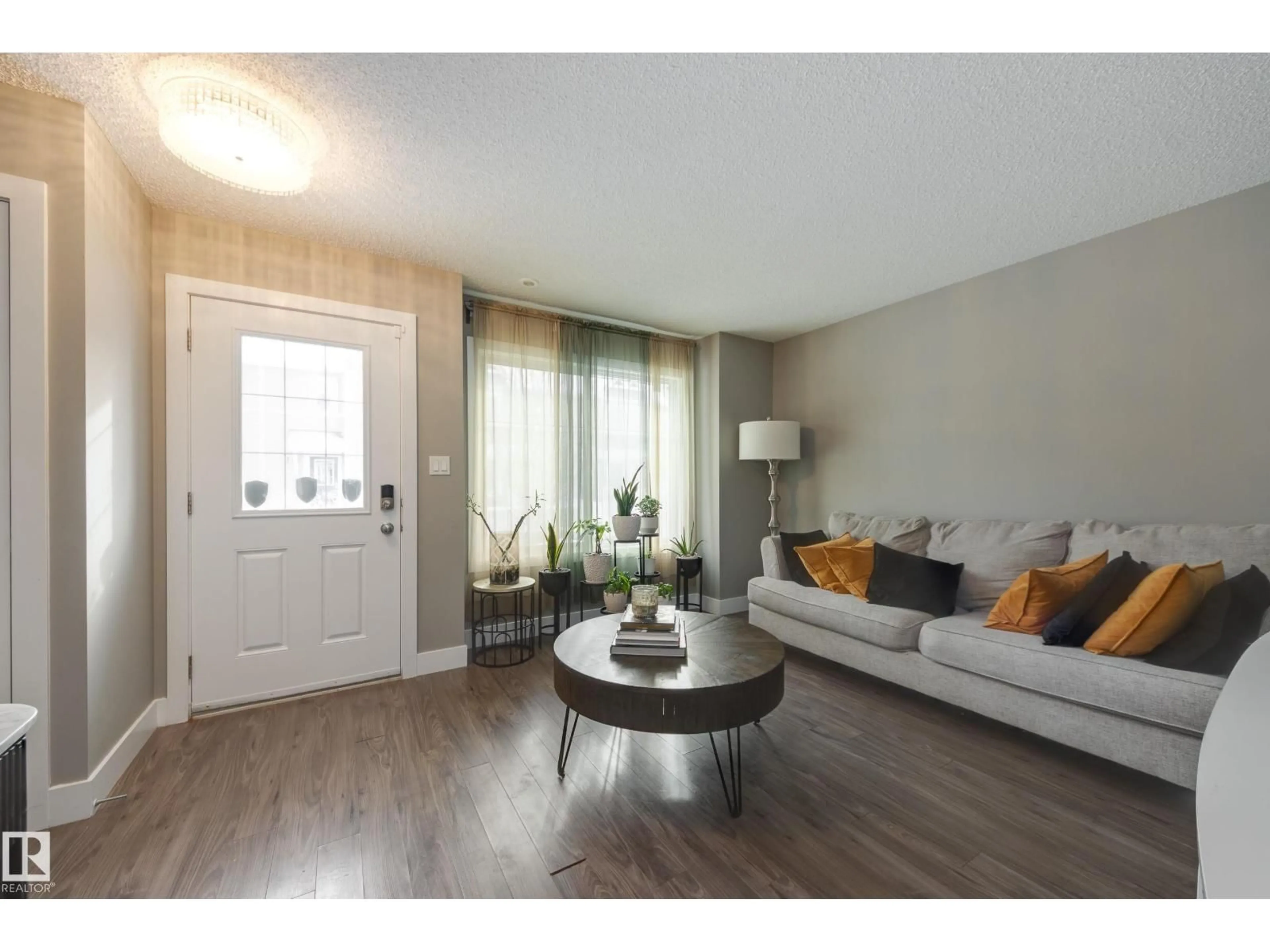 Living room with furniture, wood/laminate floor for 415 - 39 CLAREVIEW RD, Edmonton Alberta T5A0Z6