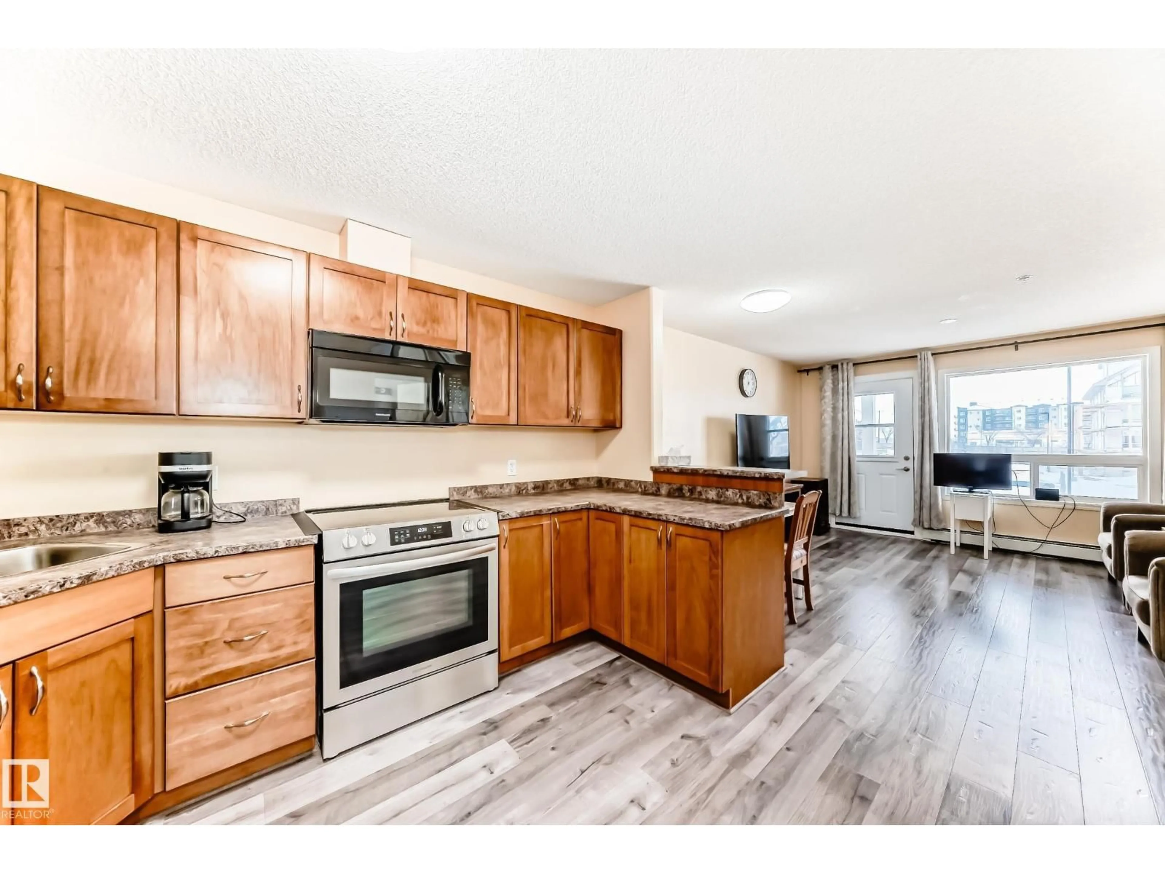 Open concept kitchen, wood/laminate floor for 320 - 2221 CLAREVIEW STATION DR, Edmonton Alberta T5Y0E3