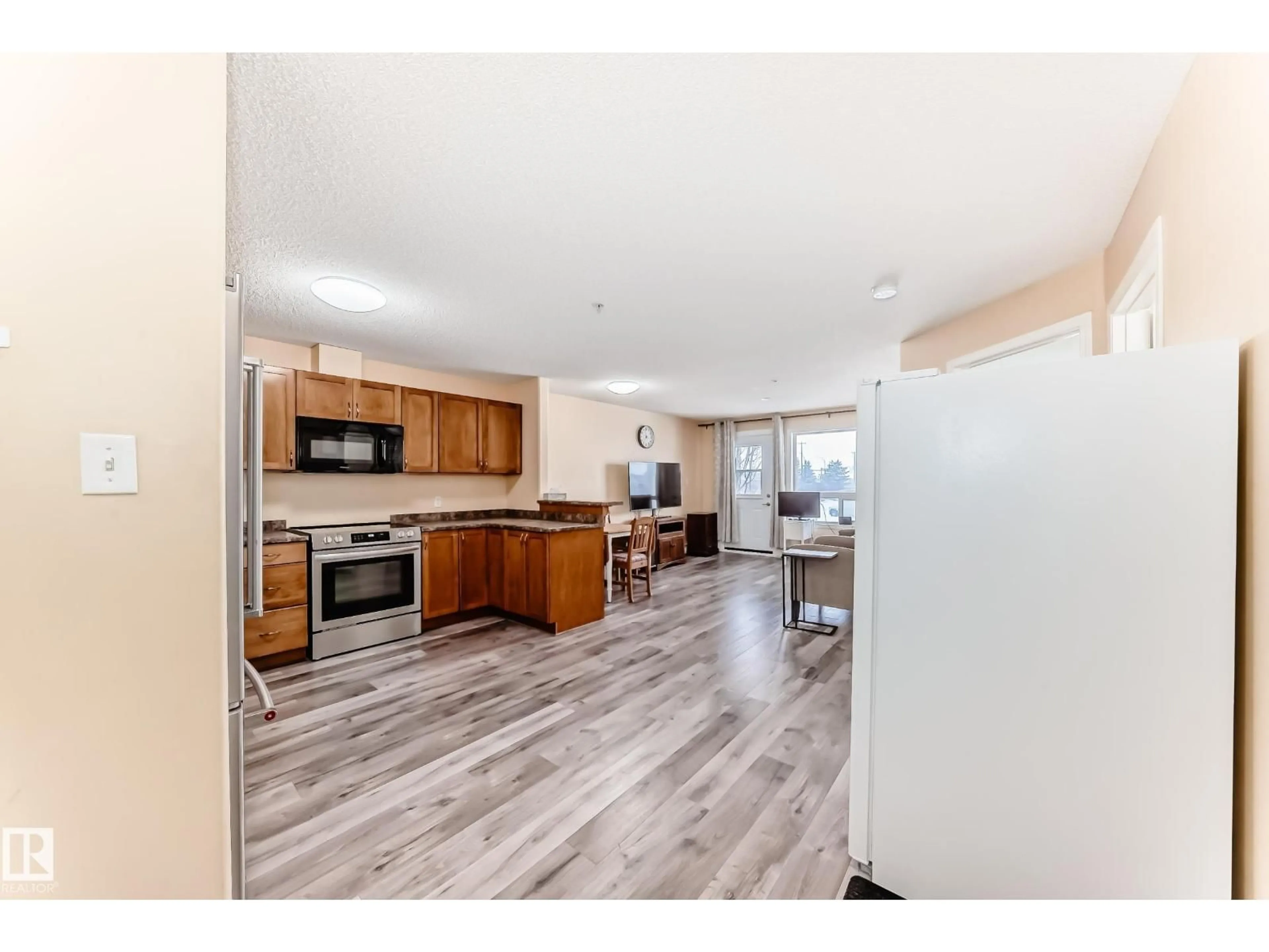 Open concept kitchen, wood/laminate floor for 320 - 2221 CLAREVIEW STATION DR, Edmonton Alberta T5Y0E3