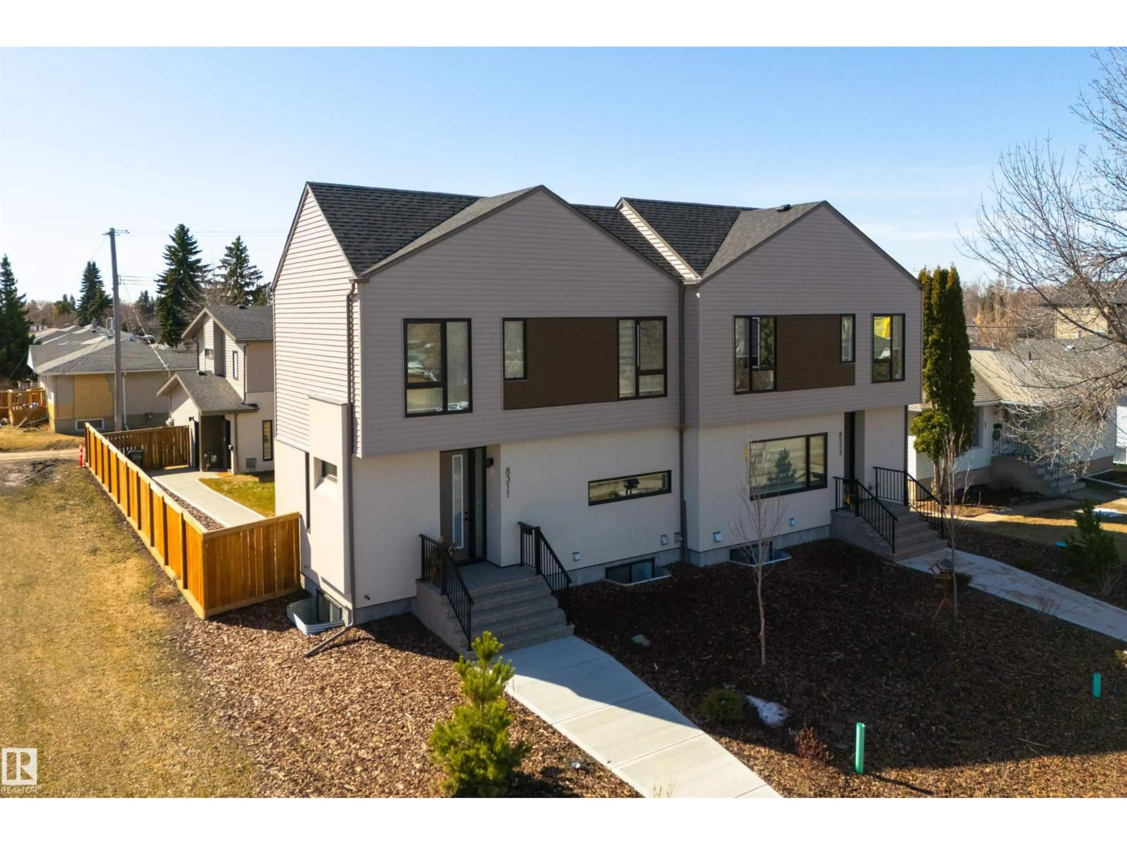 Home with vinyl exterior material, street for NW - 8311 & 8313 76 AV, Edmonton Alberta T6C0H9